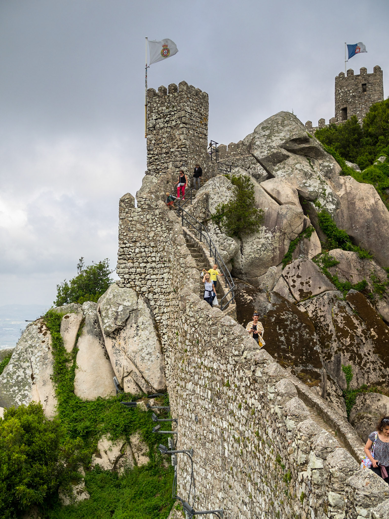 Tourists walking along Sintra's Moorish Castle walls