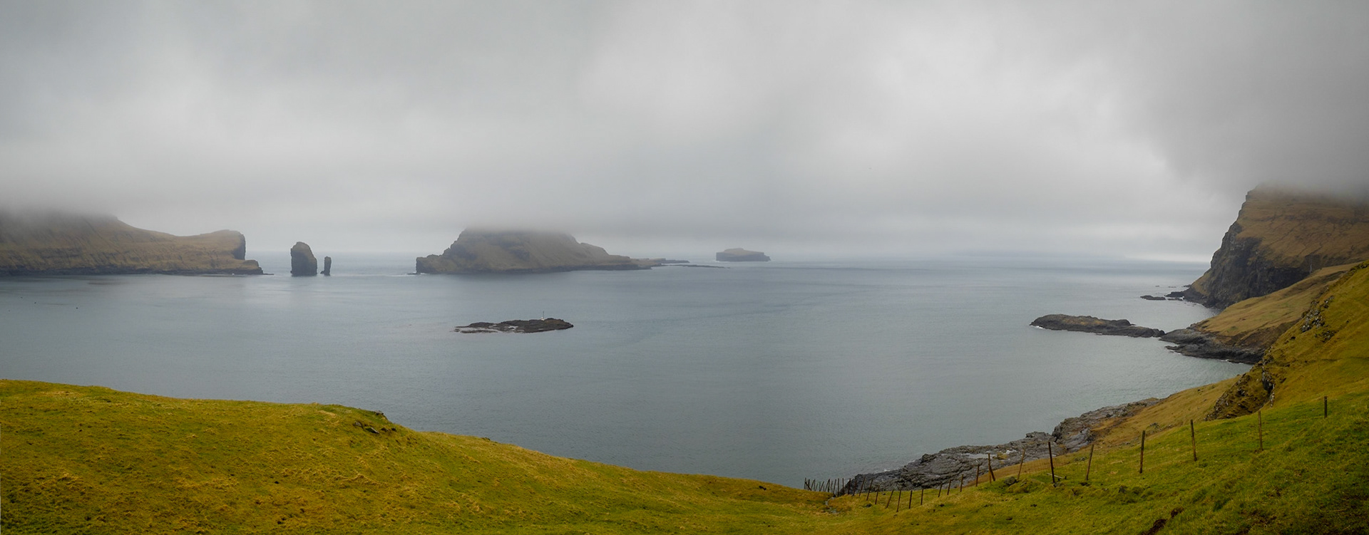 Gáshólmur islet and Tindhólmur under low clouds seen from Vágar island