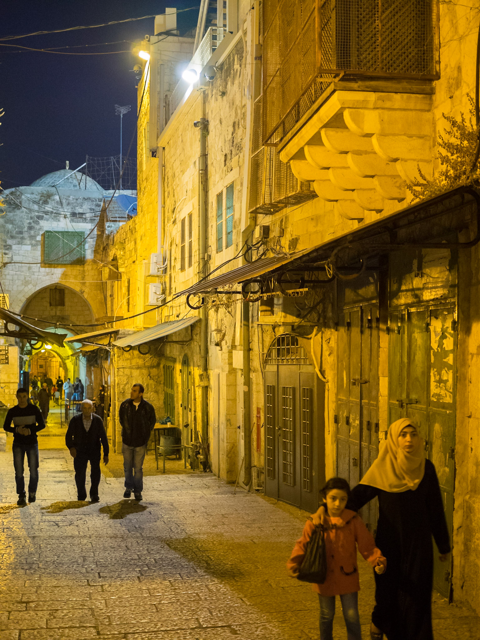 Muslims walking at night in Old Jerusalem Muslim Quarter