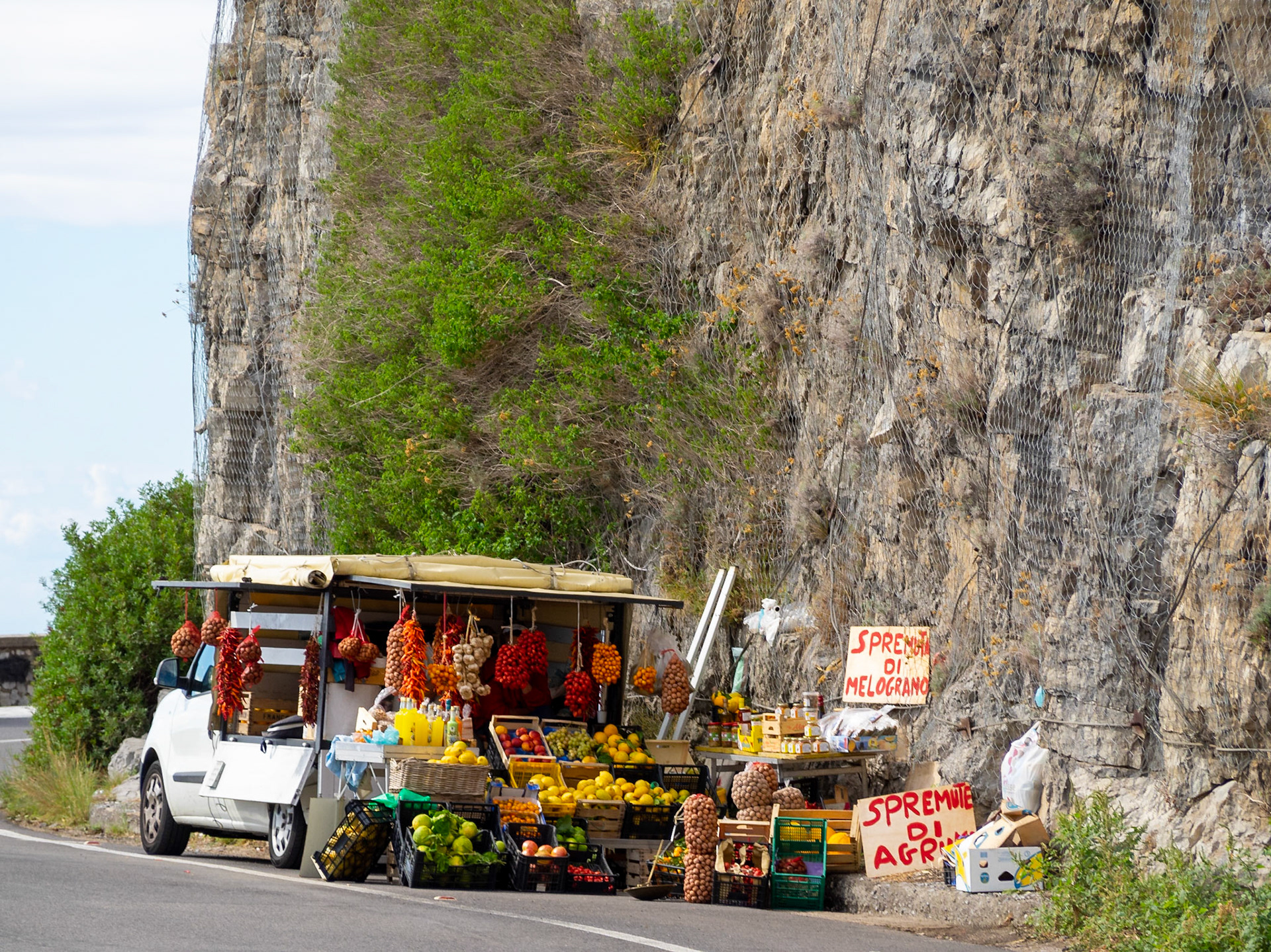 A truck selling fruits and vegetables on the roadside in Amalfi coast