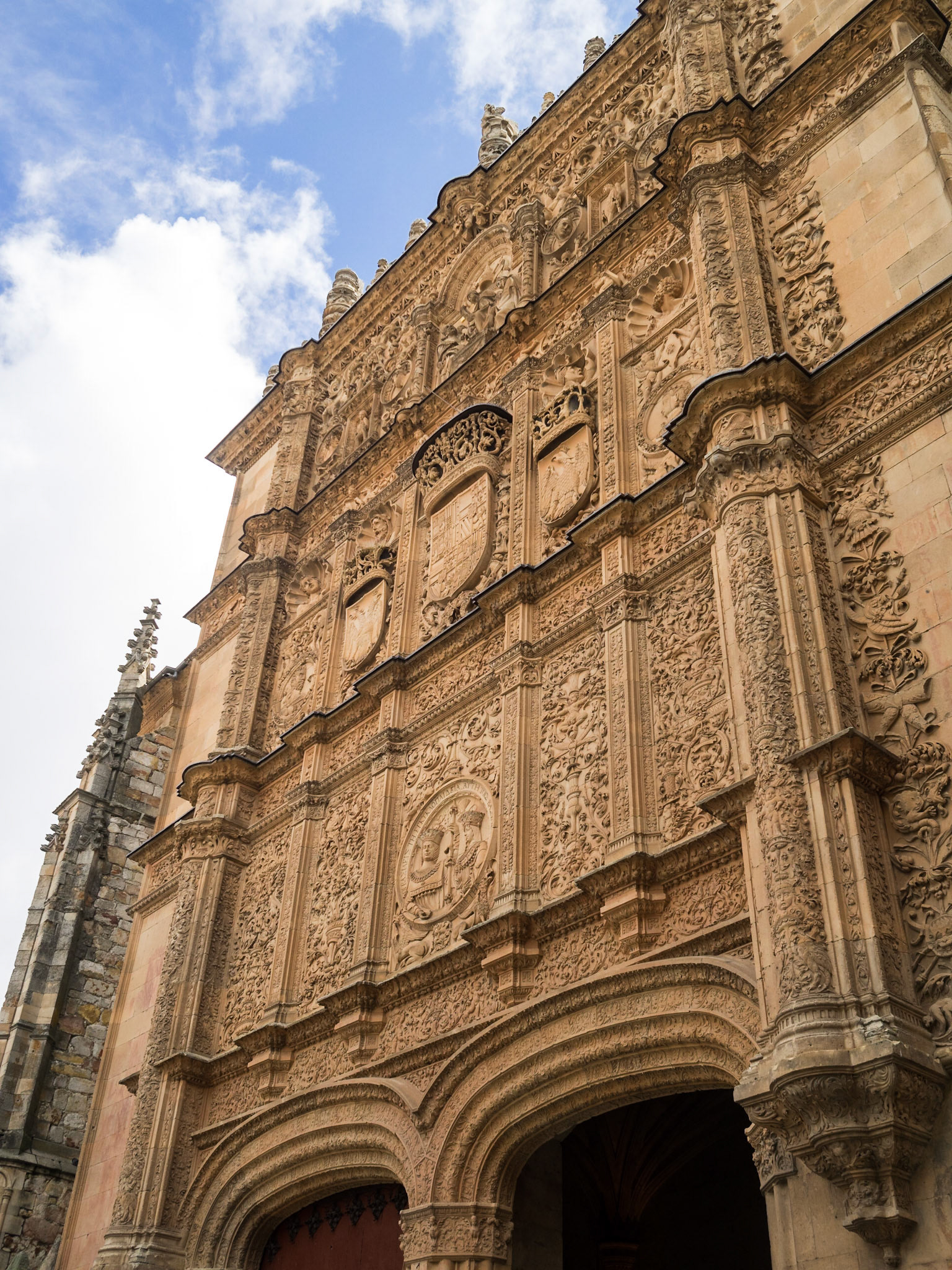Detail of the stone carved facade above the doorway to the Esculeas Mayores of Salamanca University