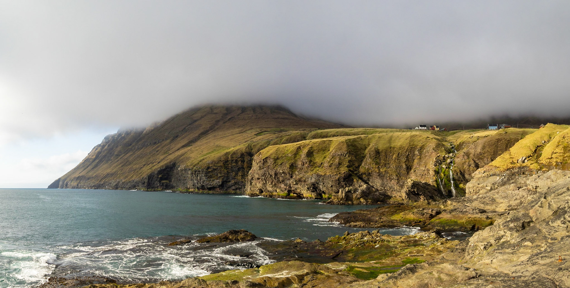 North Vidoy coastline in the sun below low clouds