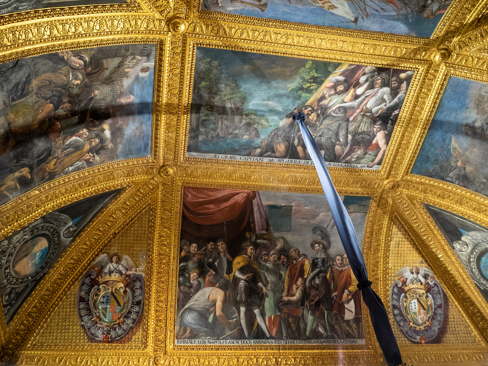 Naples Royal Palace Hall of the "Great Captain", ceiling painting by Giovan Battista Caracciolo of the Great Captian conquers all Calabria, and below, The Ambassadors offering the keys to the city of Naples