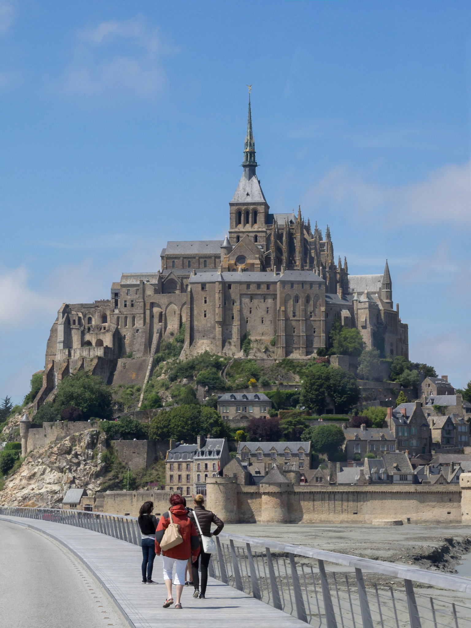 Tourists walking in the bridge to Mont Saint-Michel