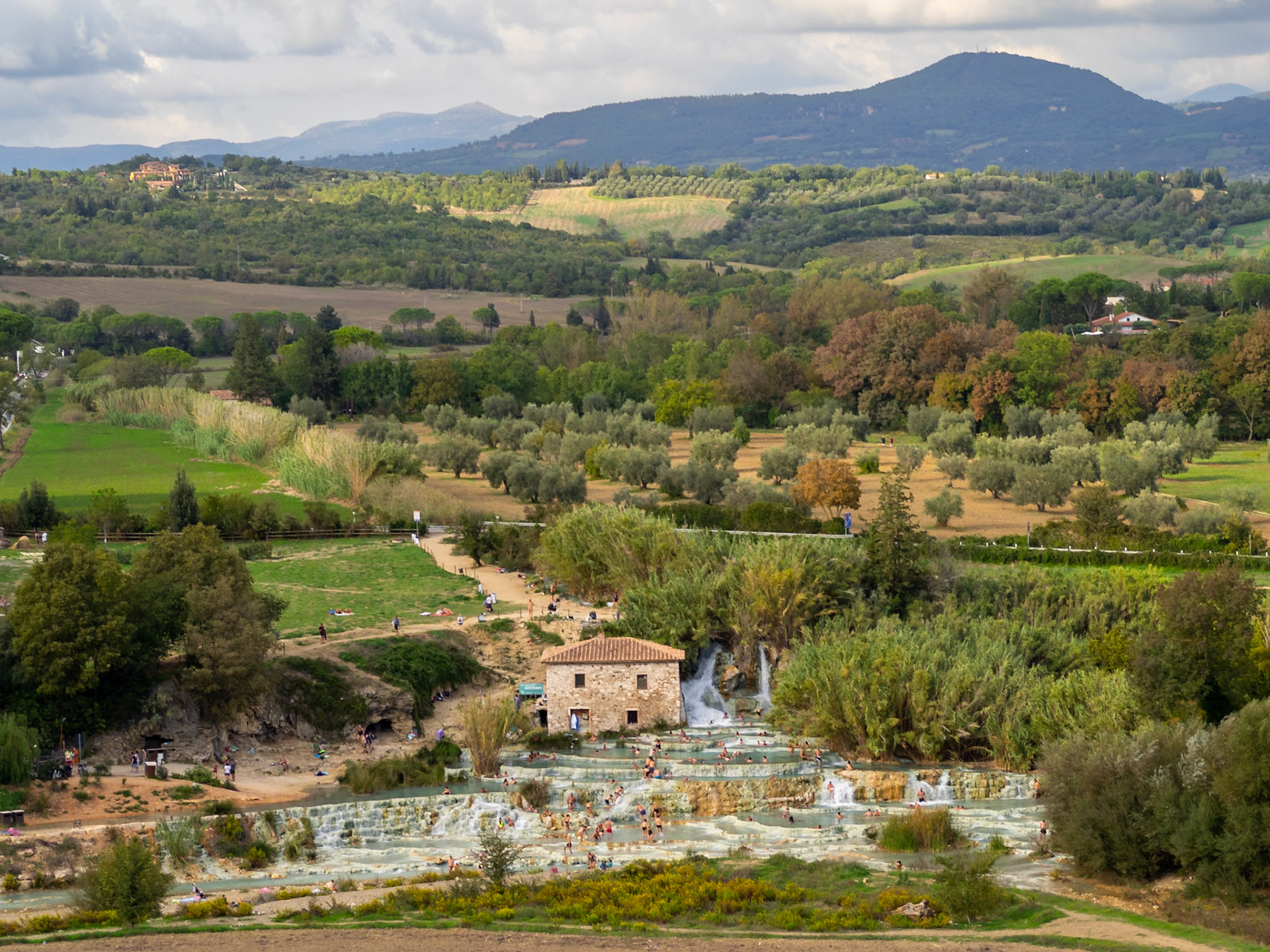 Tuscany landscape with Cascate del Mulino between the green and the hills