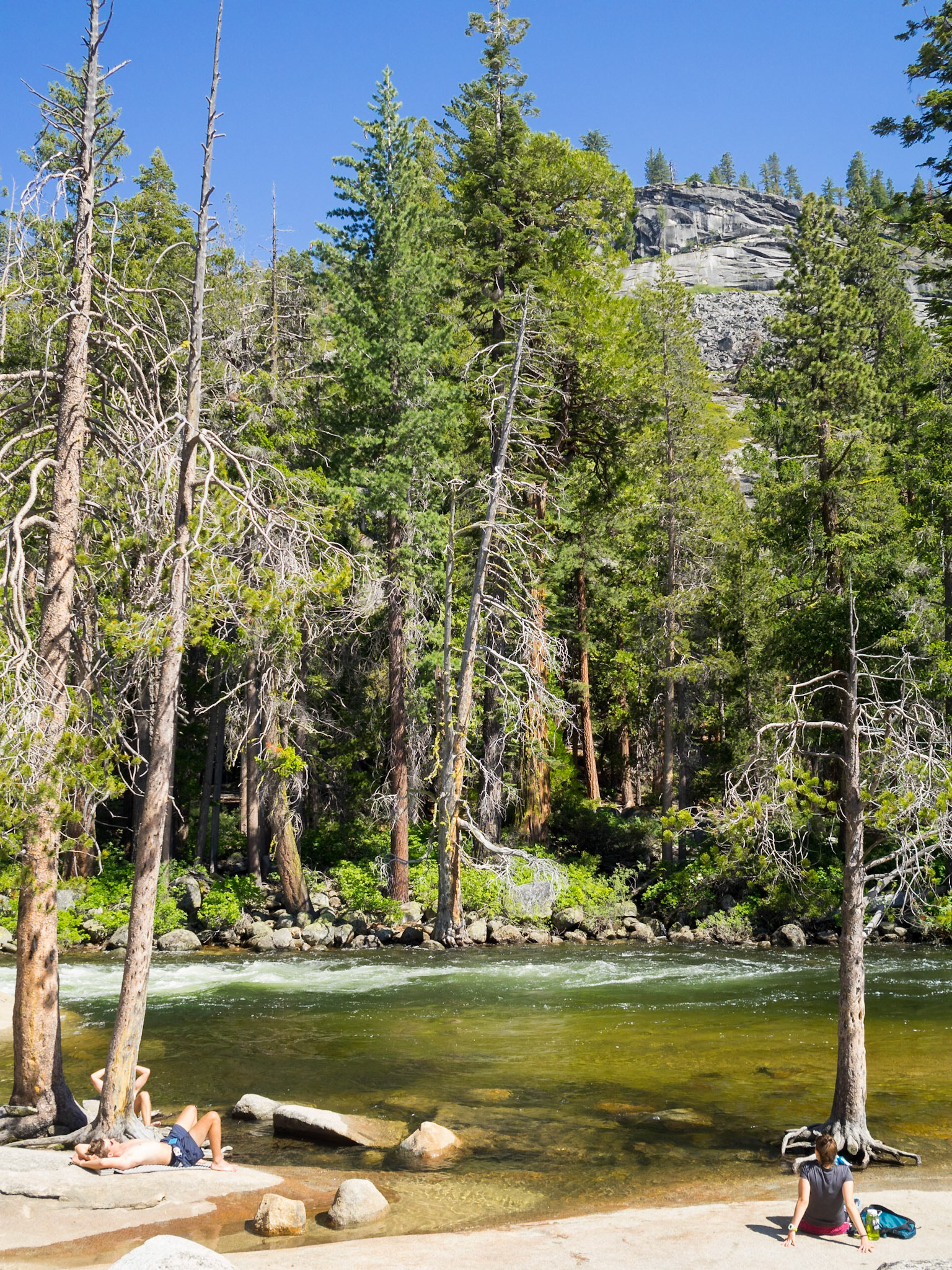 Resting by the tranquil Merced River at the top of Nevada Falls