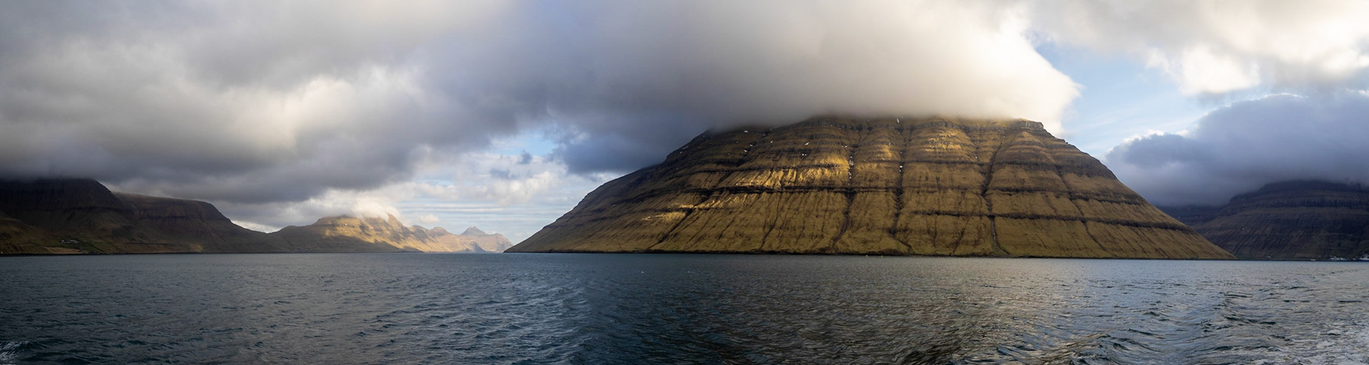 Panorama of Kunoy and Kalsoy islands with low clouds