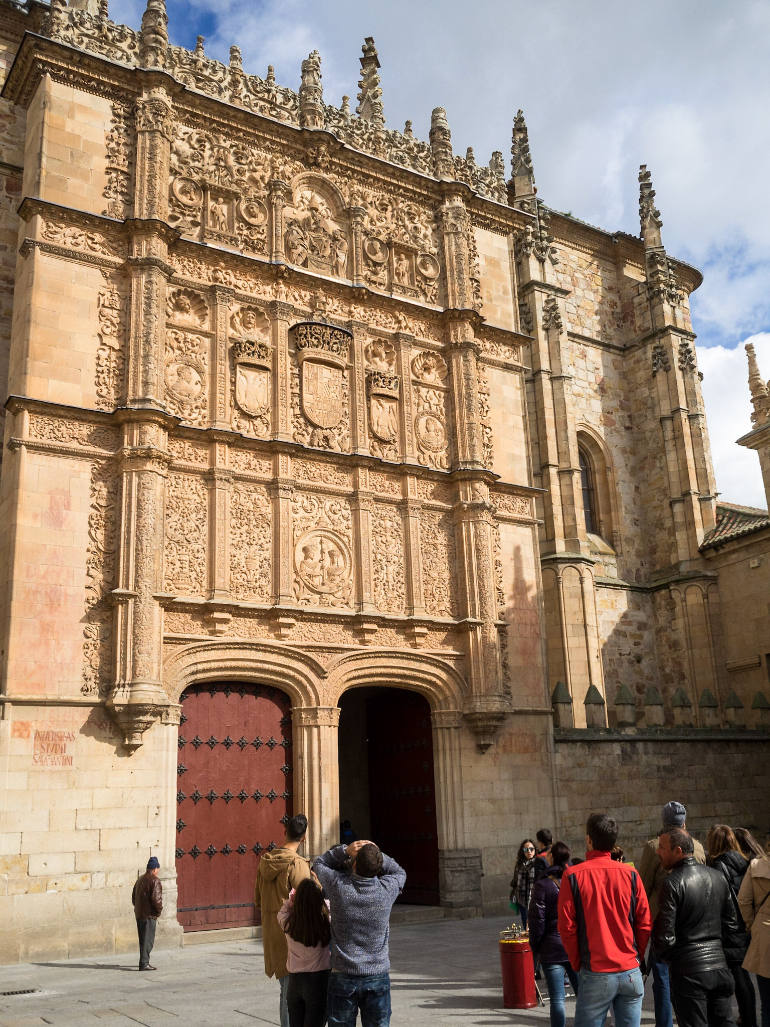 Tourist group observing the doorway to Escuelas Mayores Salamanca University