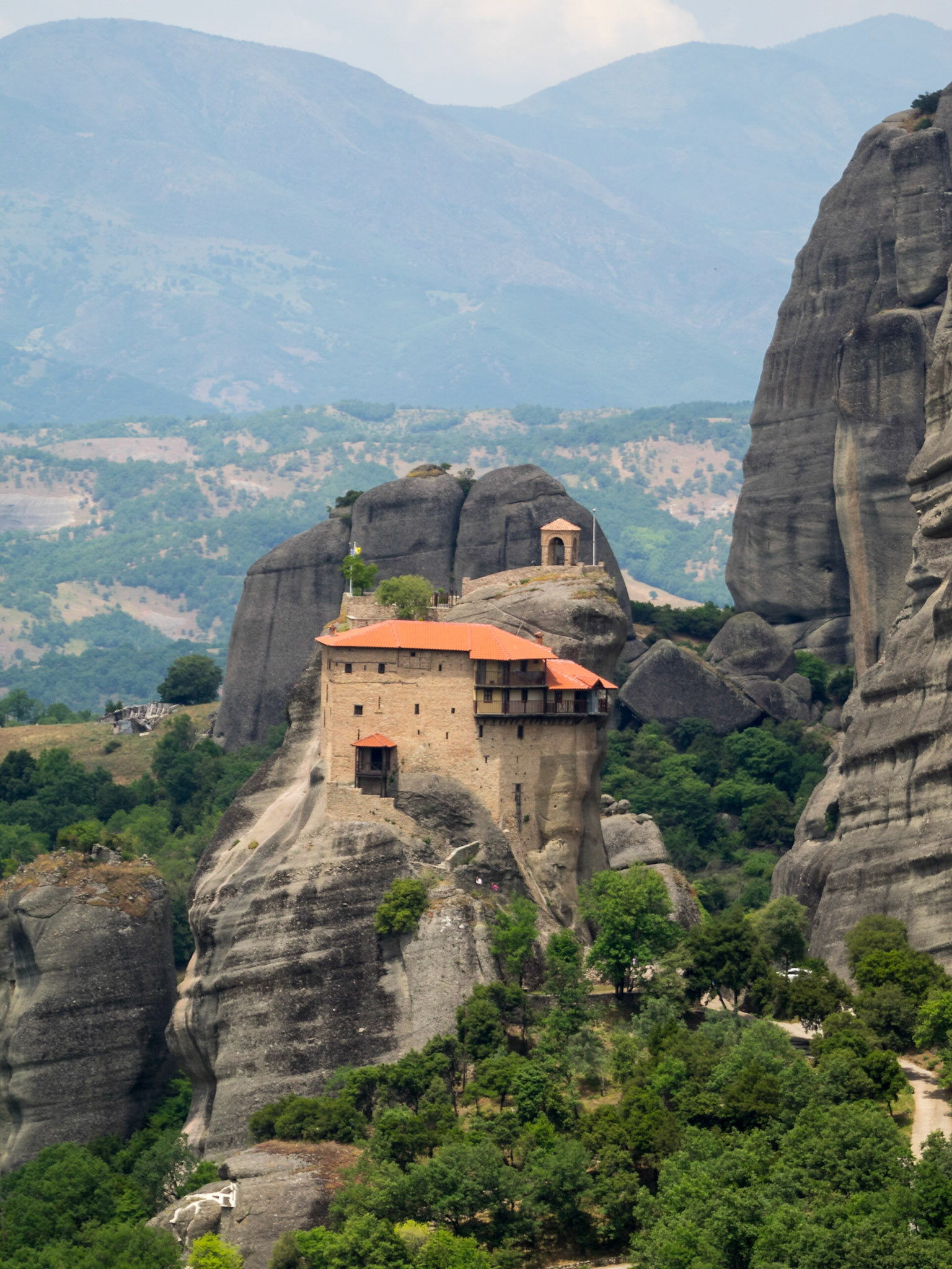 Moni Agiou Nikolaou monastery atop a rock in Meteora landscape