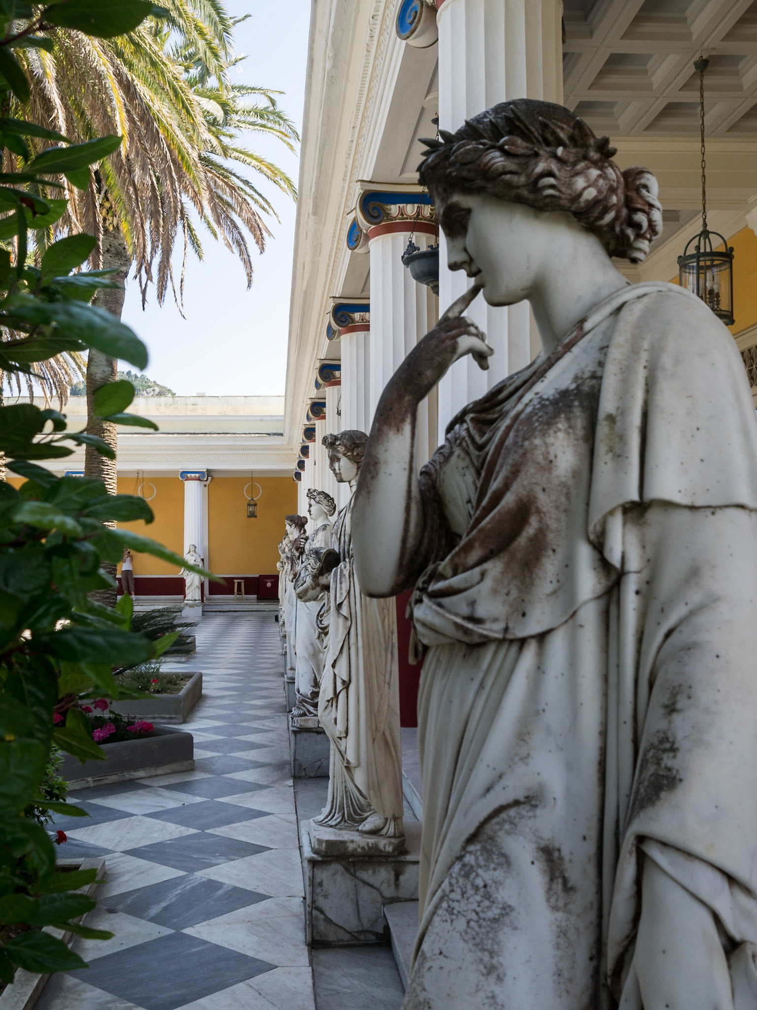 Statues lined up in Achillion Palace patio