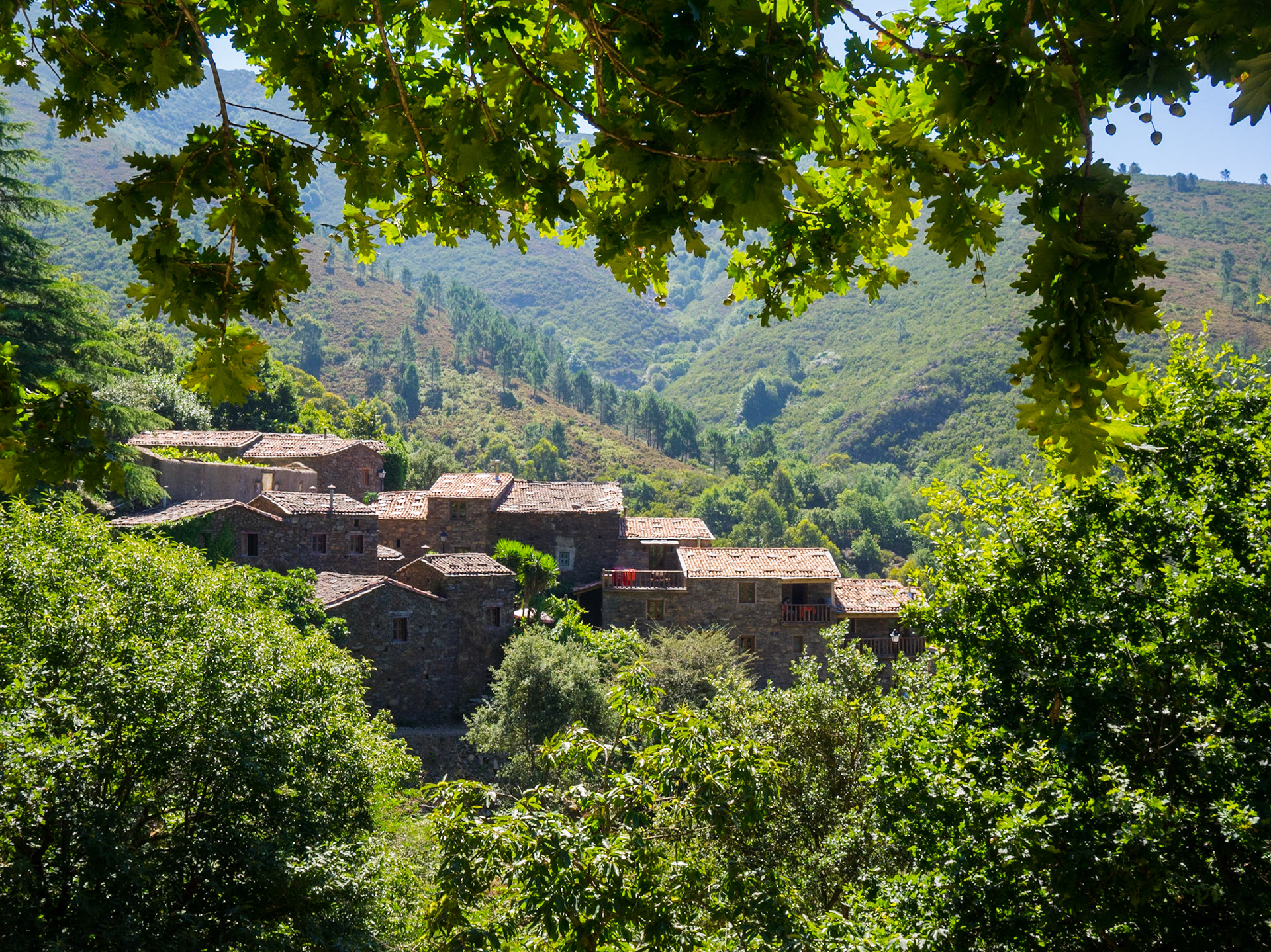 Cerdeira schist hamlet seen between the forest trees
