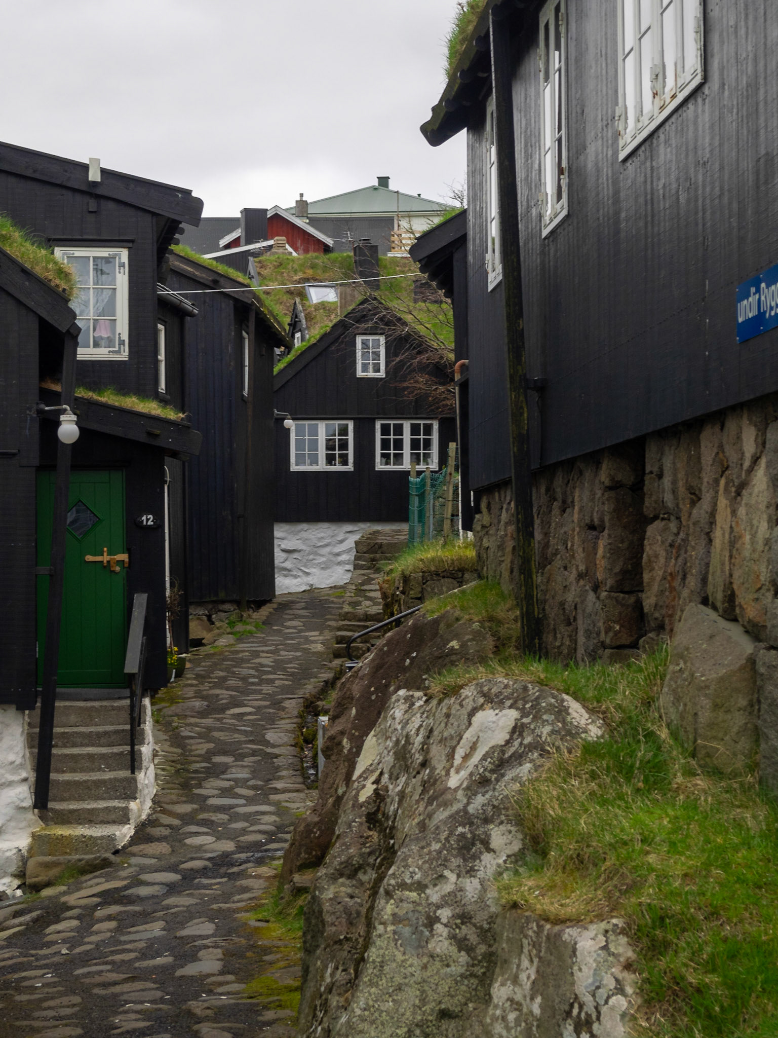 Old Tórshavn cobbled street and black wooden turf roofed houses