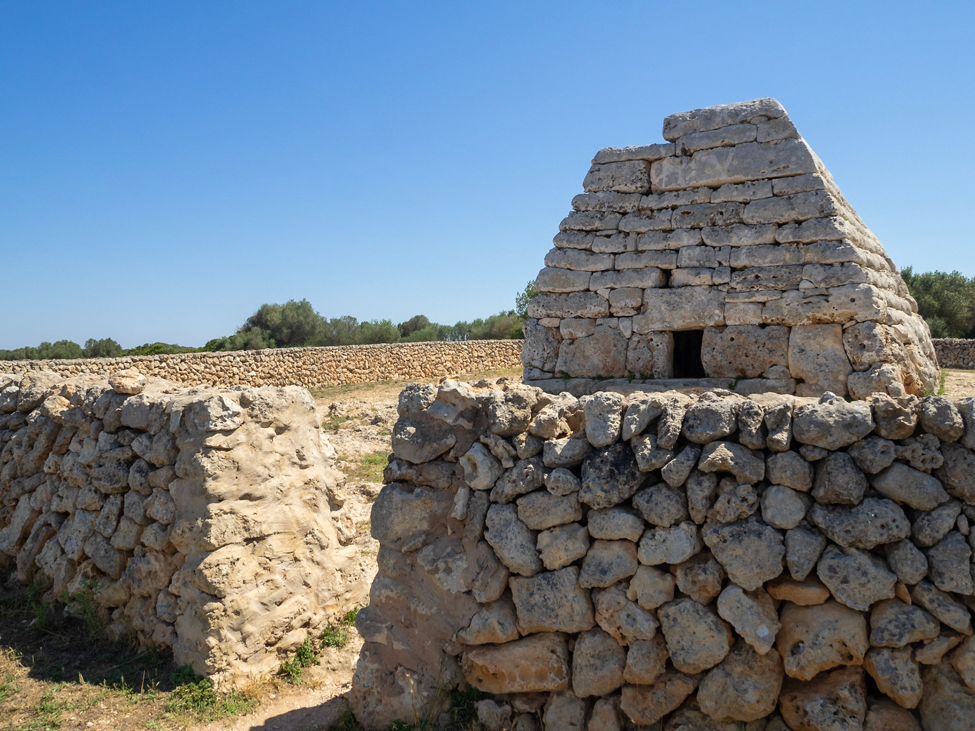 Naveta des Tudons, megalithic chamber tomb and stone wall, Menorca