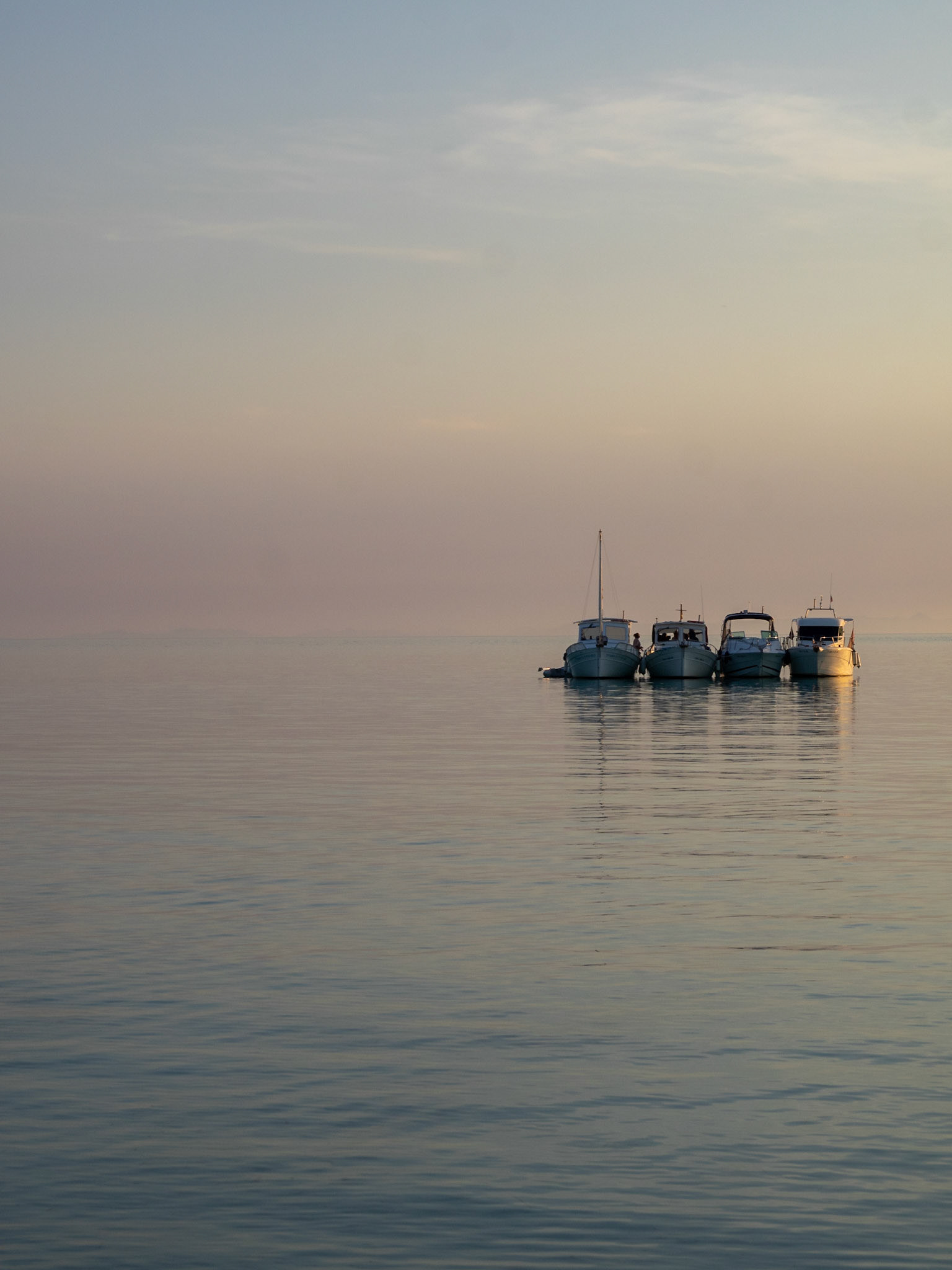 Boats floating in the dusk light