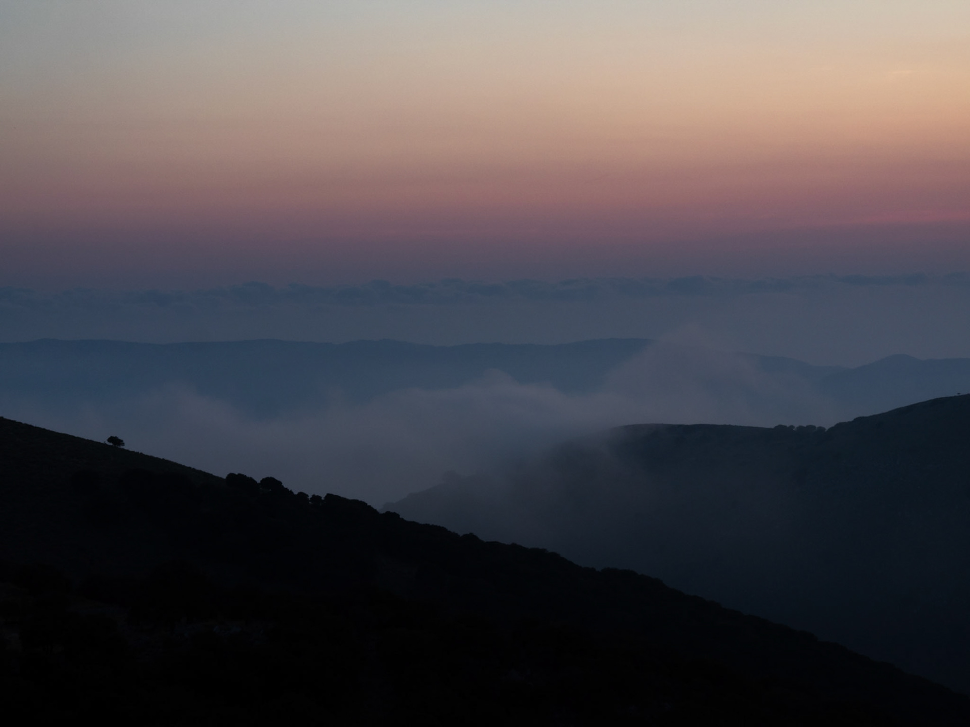 Clouds covering the mountains at sunset in Kefalonia