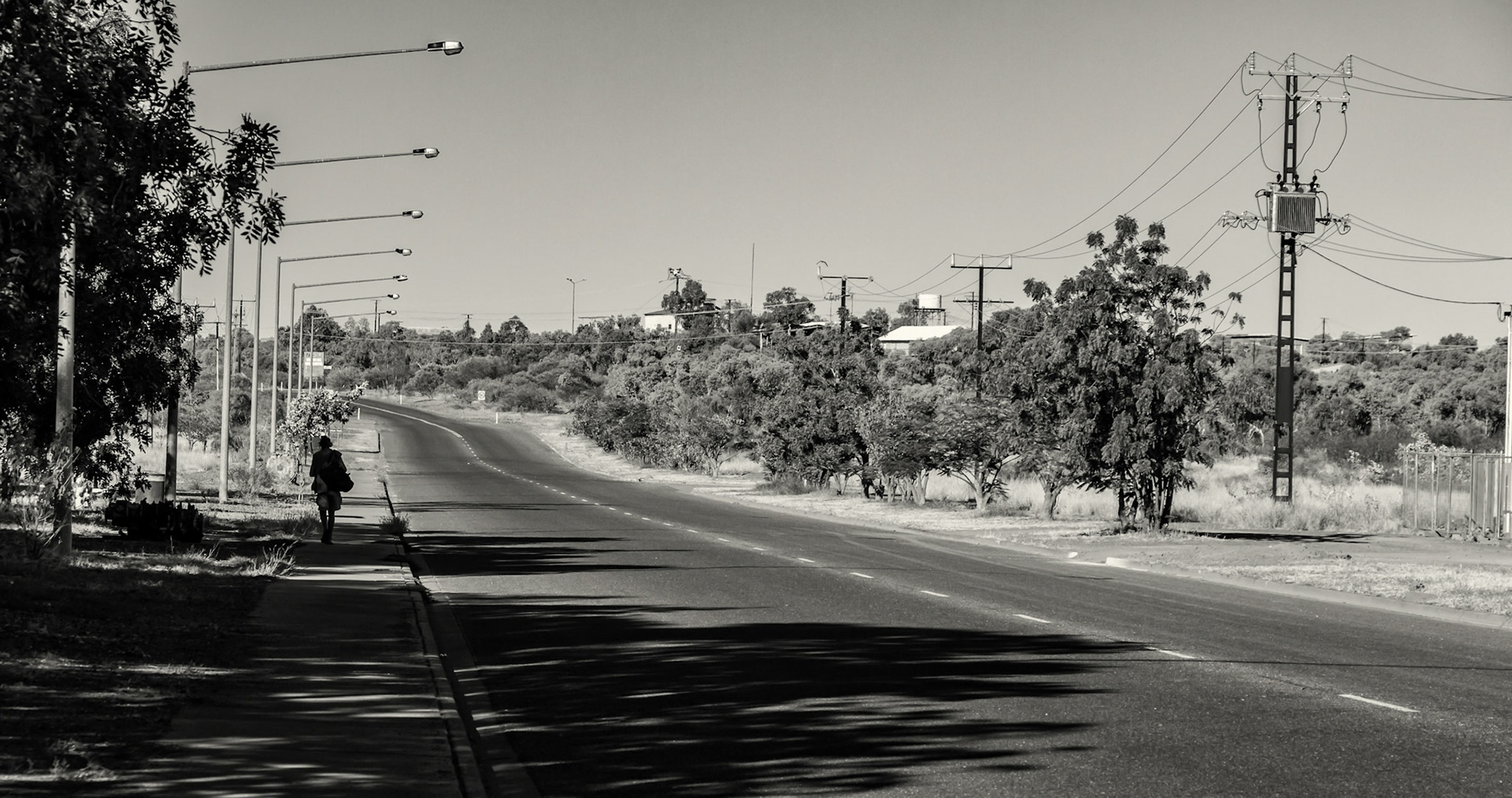 Long walk home on Peko Road, Tennant Creek in Northern Territory, Australia