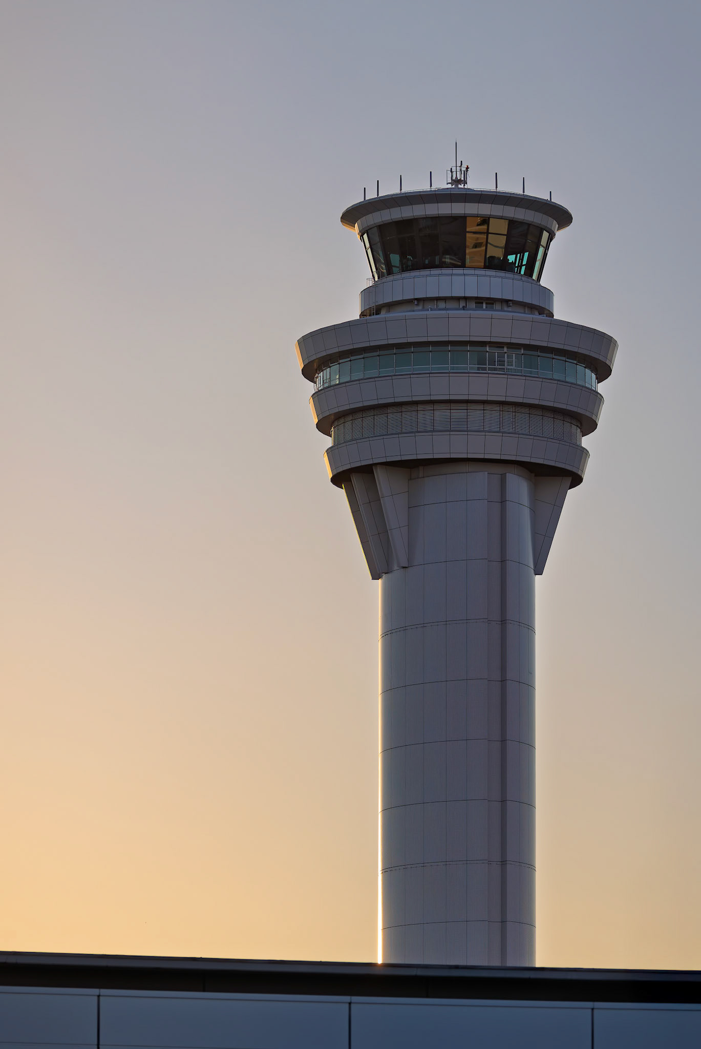Sunset over the control tower from Terminal 2 viewing platform at Haneda Airport in Tokyo, Japan
