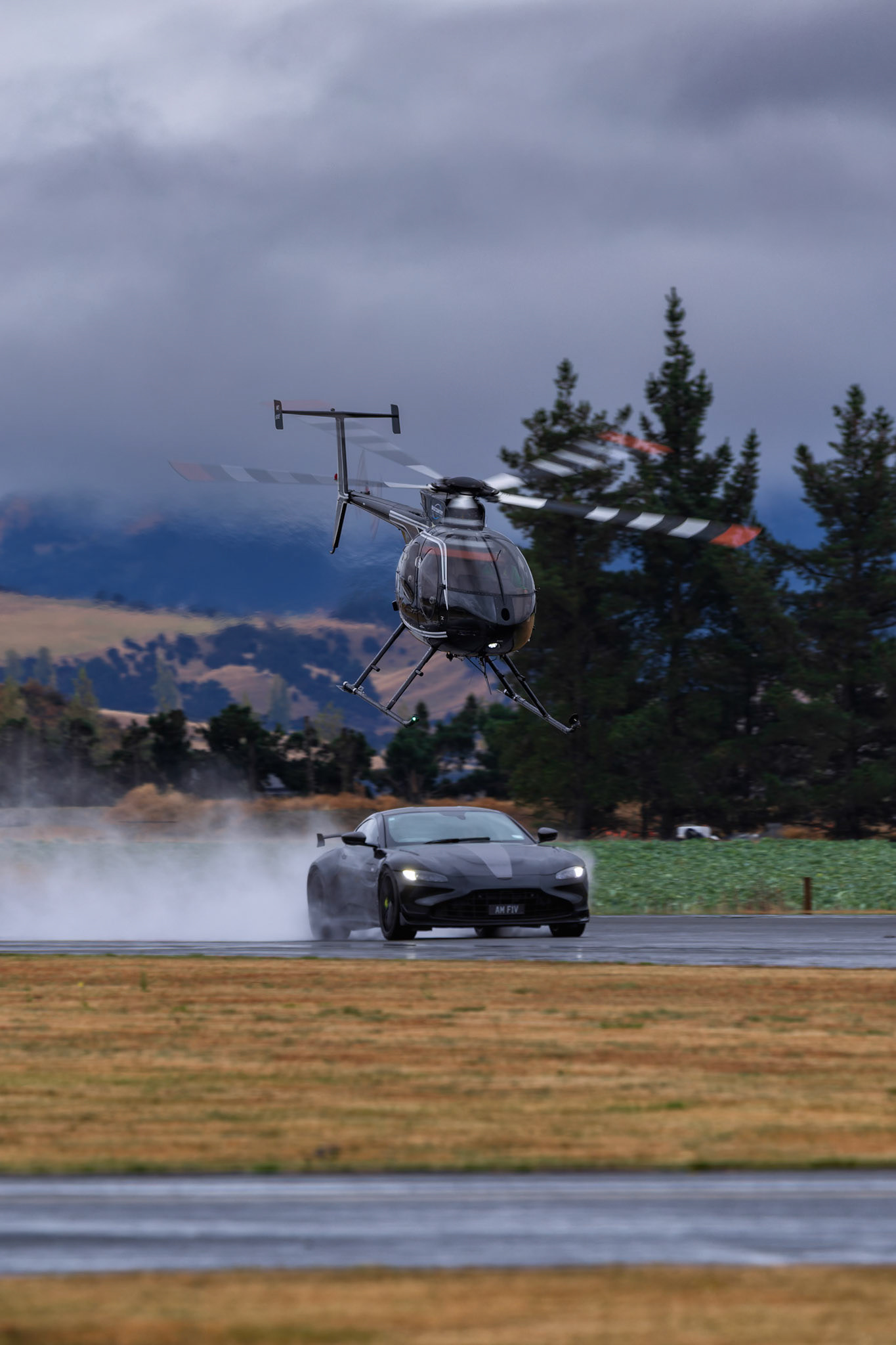 MD Helicopters MD 500E [ZK-HAC] vs 2022 Aston Martin V8 Vantage F1 Edition on display at Warbirds over Wanaka, New Zealand