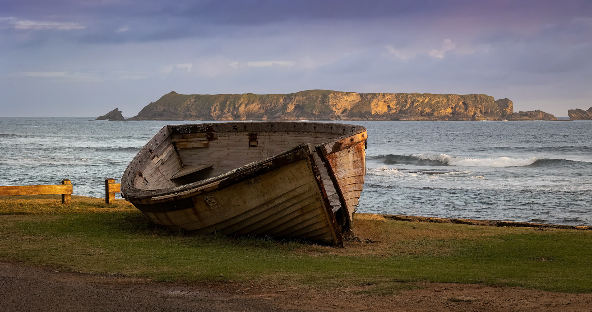 The sun setting over the Boat Shed and Philip Island at Kingston, Norfolk Island