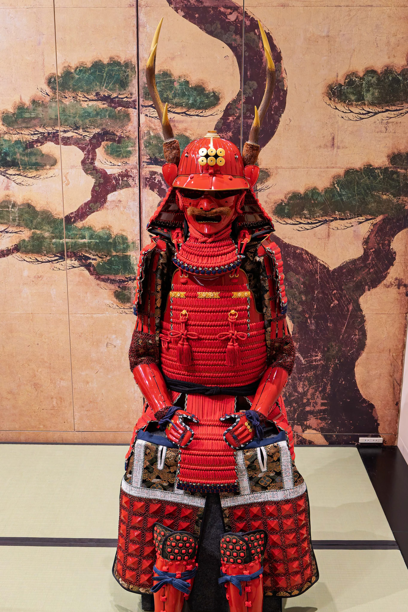 The powerful and imposing look of the Bright red Full-body samurai Armor inspired by the Armour worn by the Warlord Sanada Yukimura on display at the Tokyo National Museum in Tokyo, Japan
