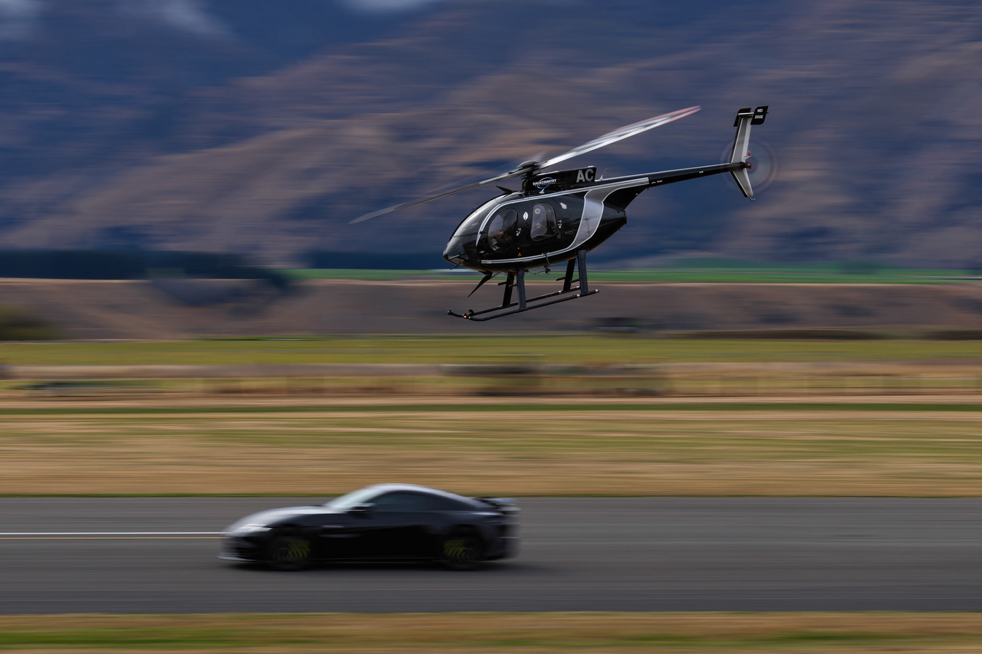 MD Helicopters MD 500E [ZK-HAC] vs 2022 Aston Martin V8 Vantage F1 Edition on display at Warbirds over Wanaka, New Zealand
