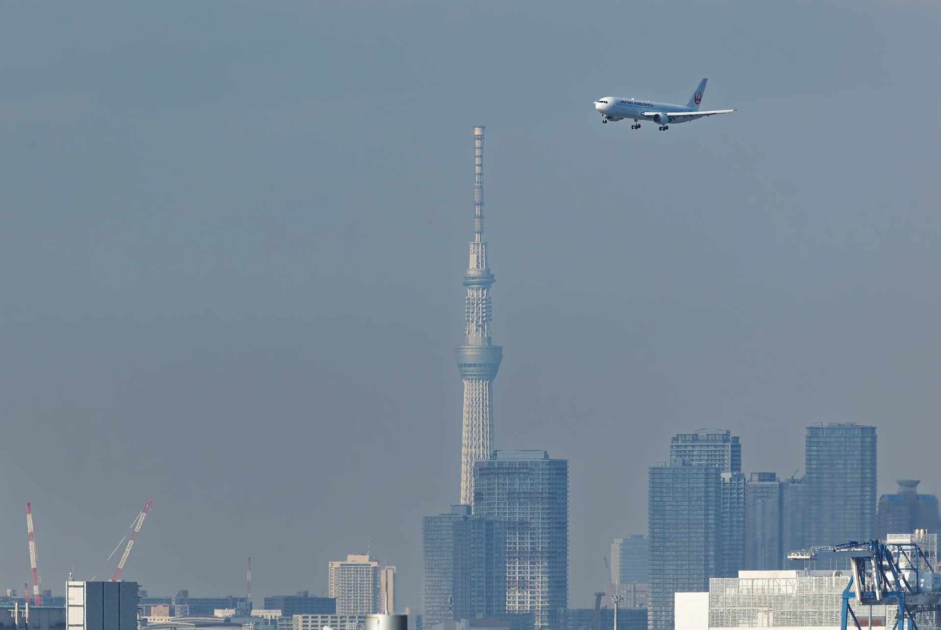 Japan Airlines approach to Haneda airport, captured from Terminal 2 viewing platform at Haneda Airport in Tokyo, Japan