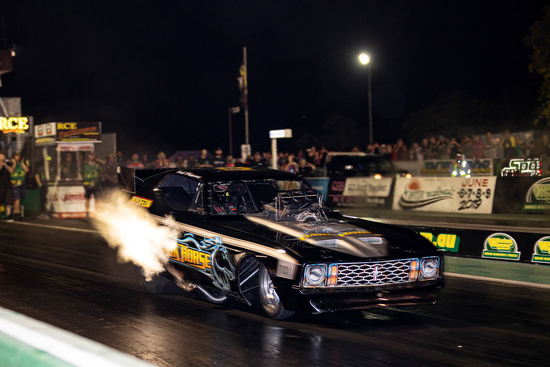 Competitor 'Dark Horse' starting a run at the Aeroflow Outlaw Nitro Funnycar event on the 9th of November, 2019 at Willowbank Raceway in Queensland, Australia