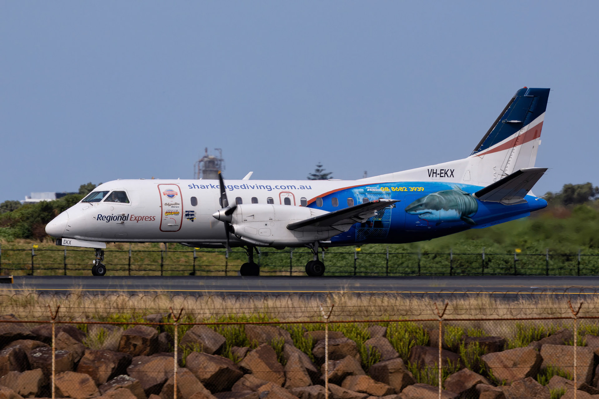 Regional Express Saab 340B (Shark Cage Diving Livery) [VH-EKX] Departing to Narrandera from The Beach, Sydney Airport, Australia