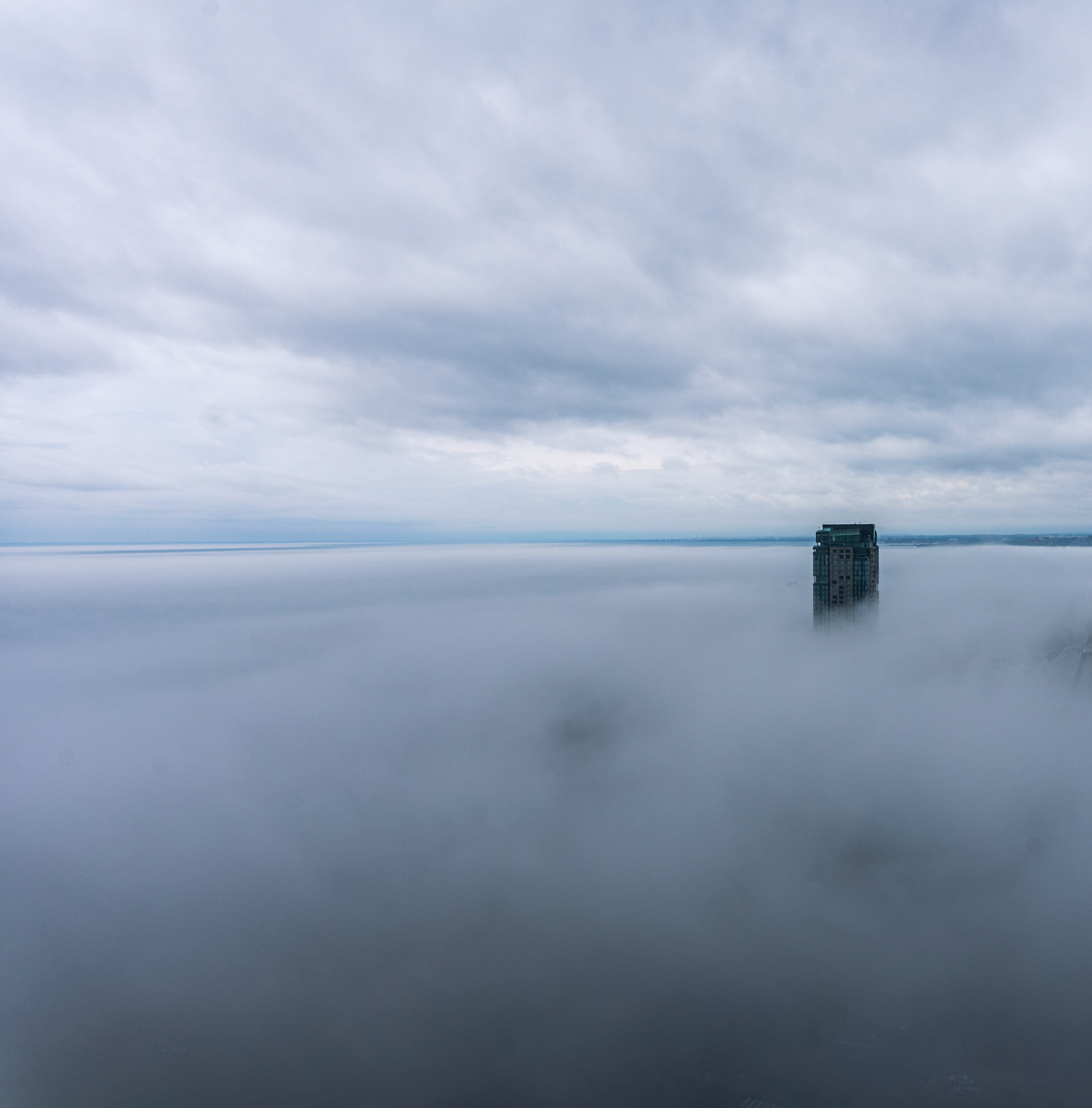 A building rises above the fog