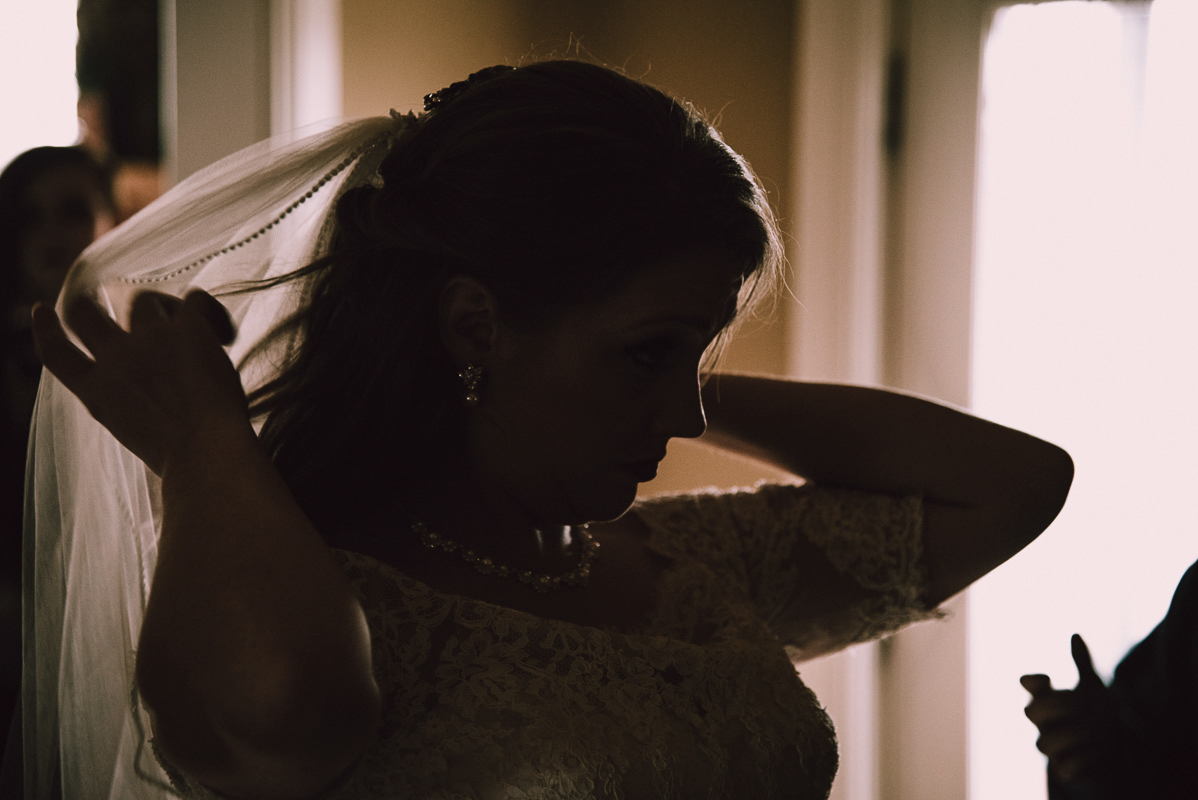 Bride adjusts her veil- artistic wedding photograph by Lexington Ky Wedding photographer Davron Bowman