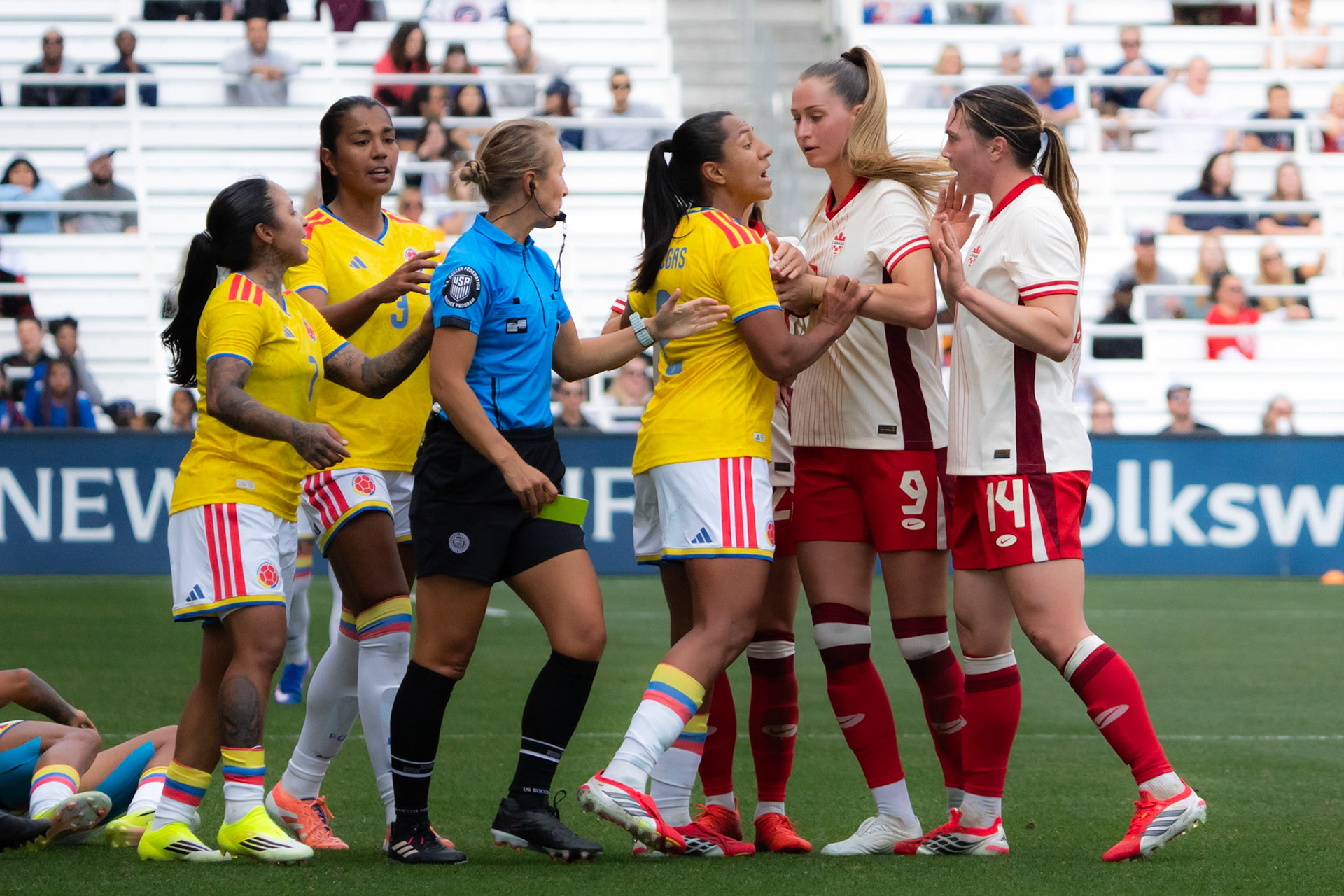 A Colombia Women’s National Team player confronts a Canadian player after a hard foul left her teammate injured on the pitch.