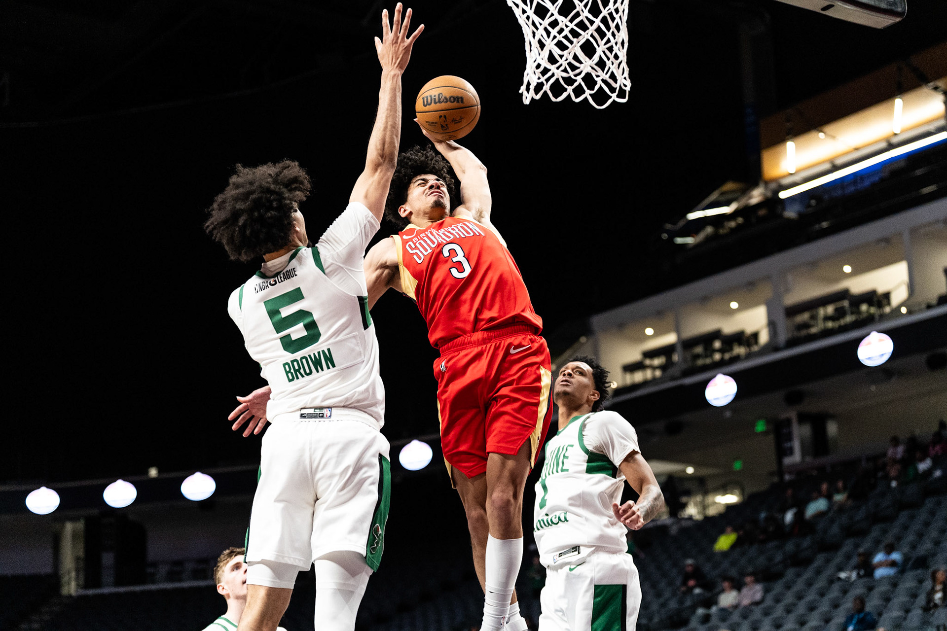 Birmingham Squadron guard D.J. Carton (3) dunks over Maine Celtics guard Kendall Brown (5).