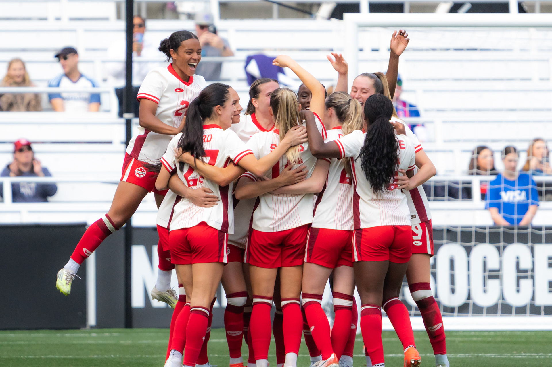 Canada Women’s National Team players celebrate after scoring against the Colombia Women’s National Team.