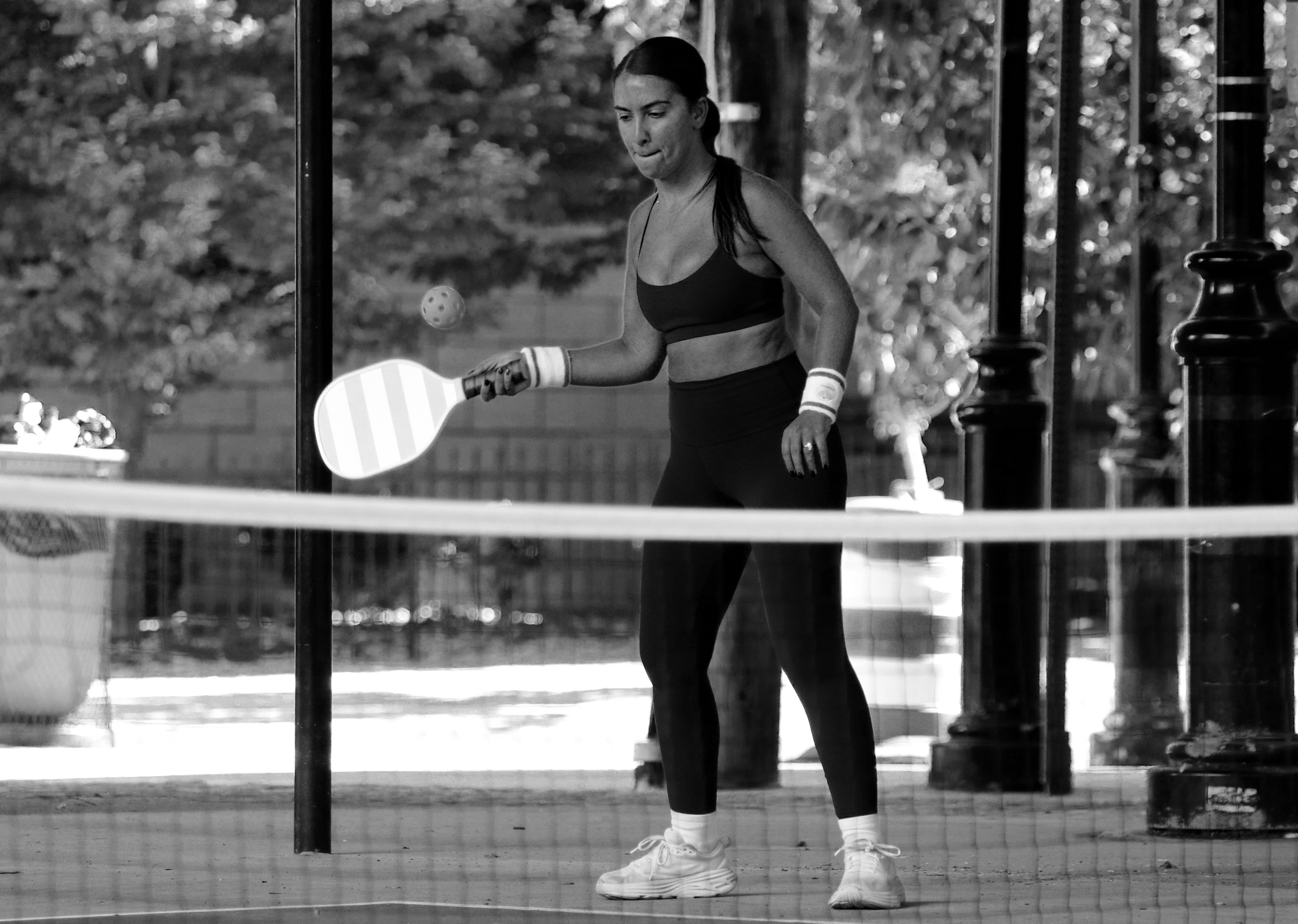 HOBOKEN, NJ, 10-05-2024 STOP MOTION OF FAST MOVEMENT: A woman plays tennis in 14th street in Hoboken, New Jersey, on October 5. This photograph captures her movement as she hits the ball, highlighting her focus in the game.