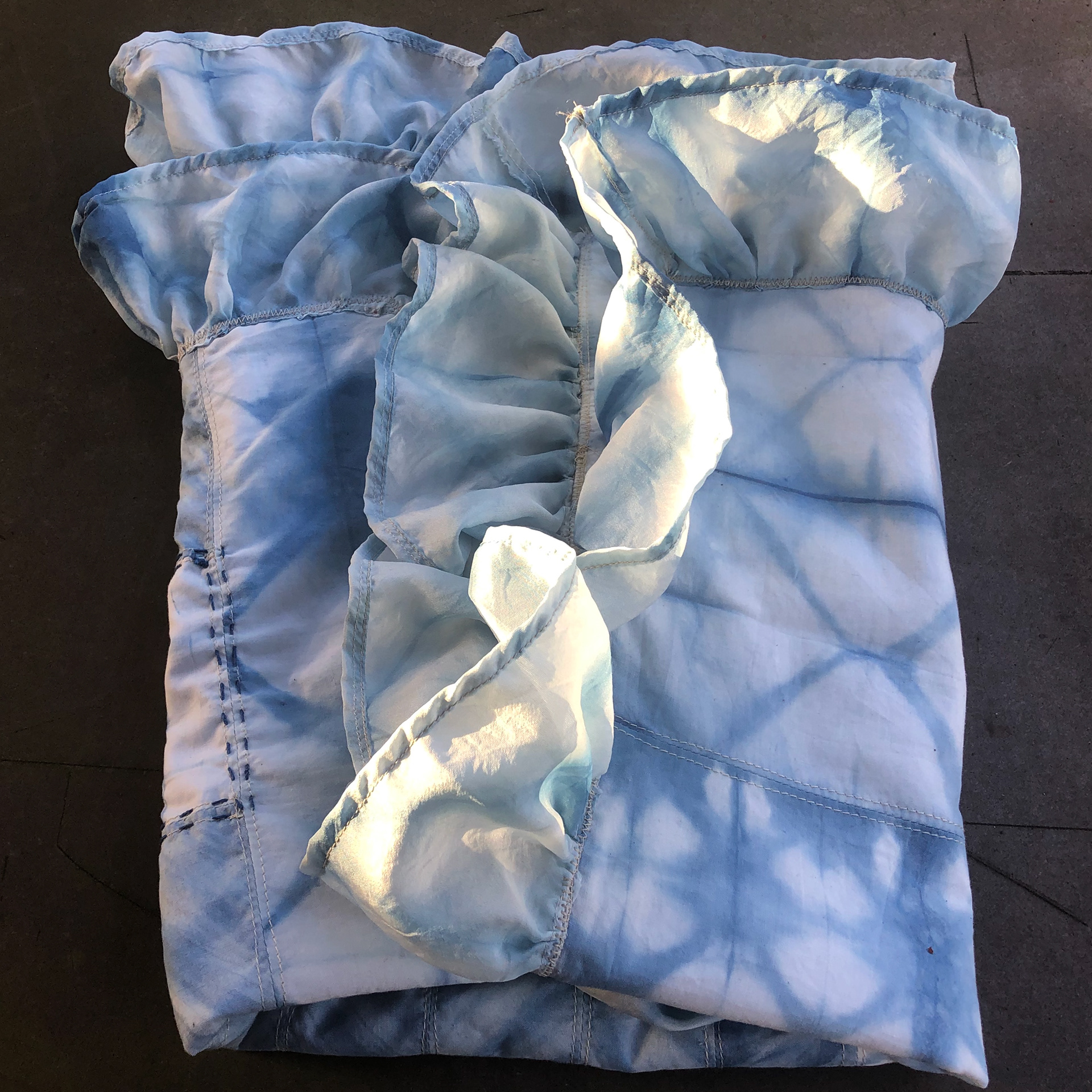 Indigo Quilt (2018) organic cotton, silk, indigo, thread // Inspired by my denim industry wearable, I learned organic indigo vat dyeing methods using shibori folds on cotton. These patterns were then pieced into a quilt with an overlay of sashiko and kantha stitches unifying the composition