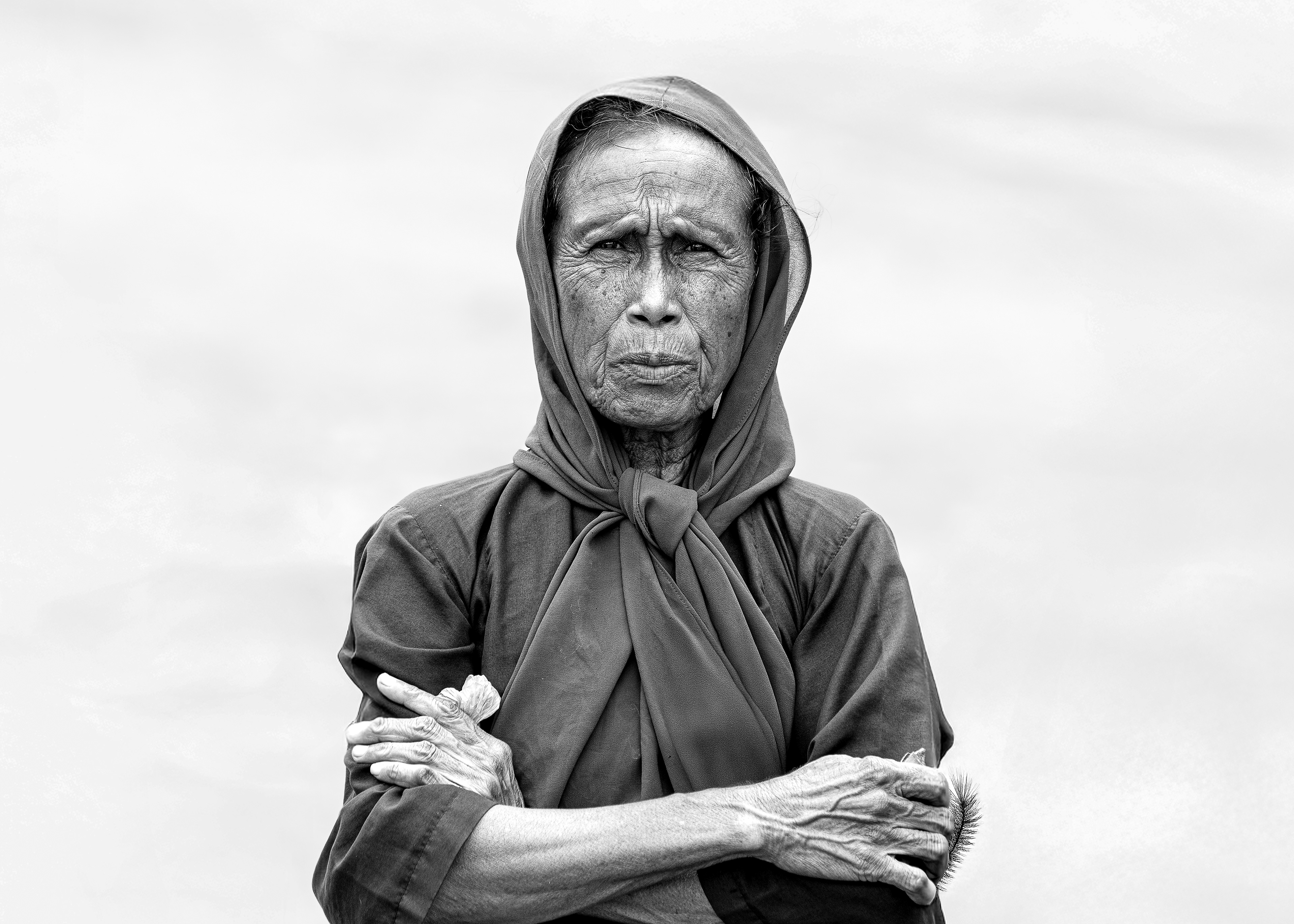 A female farmer gazes at me as I document her farm. Her eyes reflect the determination that defines her life as a farmer.