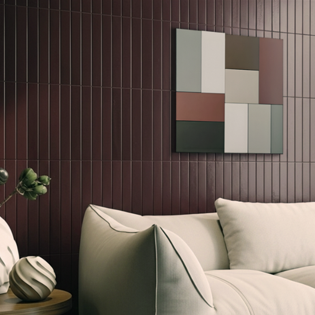 A sophisticated lounge featuring a maroon finger tile feature wall, a contemporary off-white sofa, and modern color-block wall art.
