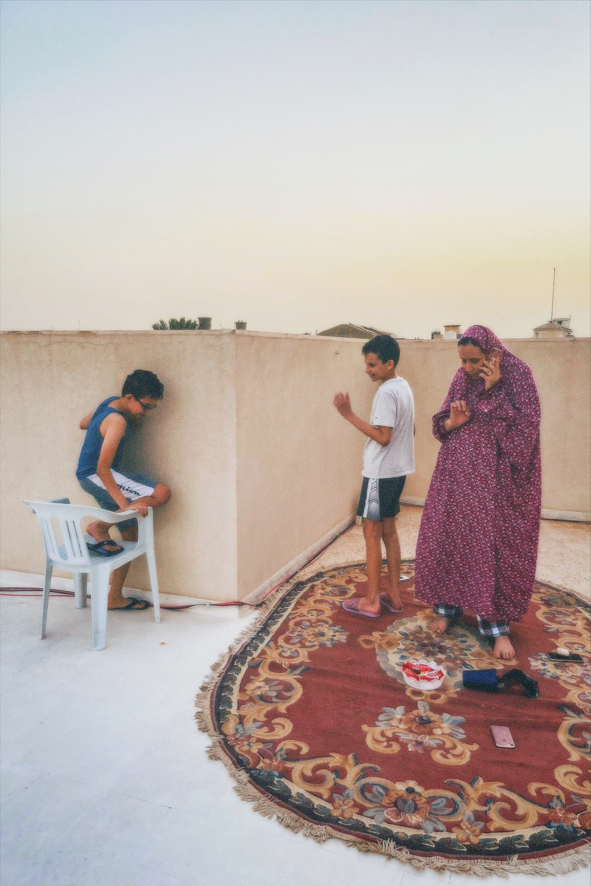 On the roof. Kids floating around. Carpets hung to dry. Cellular service, obsolete.