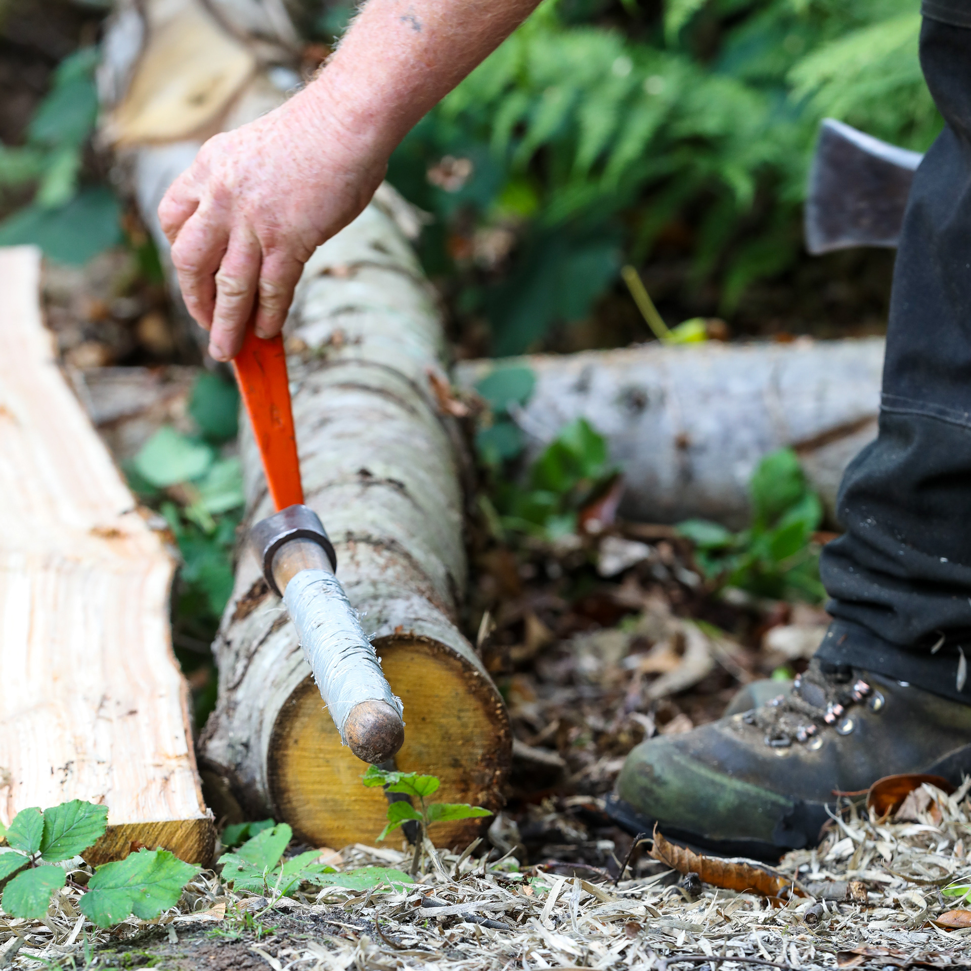 Once a split has been made a wedge can be used to split the log into two halves
