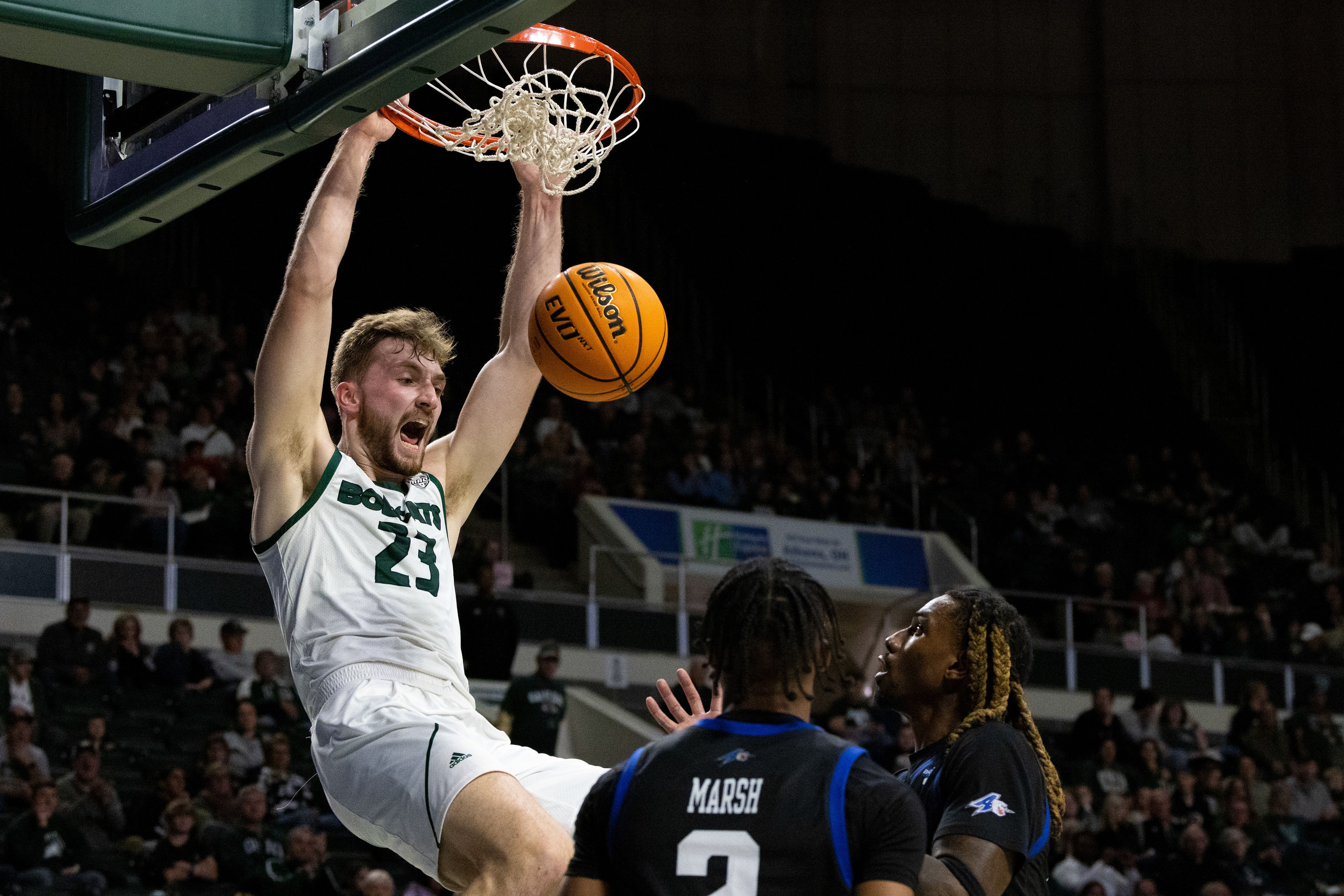 AJ Clayton (23) dunks on a UNC Asheville defender at The Convo in Athens, Ohio, Nov. 9, 2024.