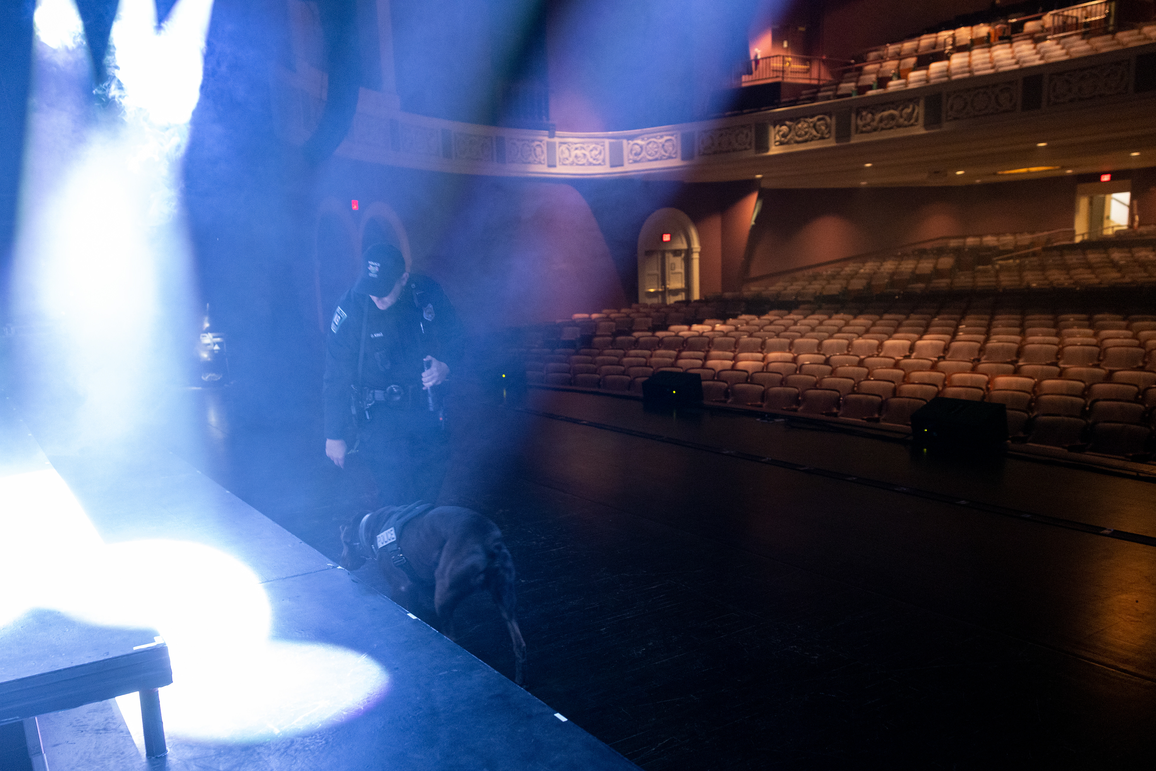 Officer King and Bach search the Templeton-Blackburn Alumni Memorial Auditorium before a concert in Athens, Ohio, Nov. 29, 2023. Bach has been trained to not be affected by any strobe lights or smoke machines. The smoke machine creates a strong smell in the air, but it does not affect Bach’s nose. “If we smell vegetable stew, we smell all the ingredients together. Bach can smell each ingredient apart,” Officer King said.