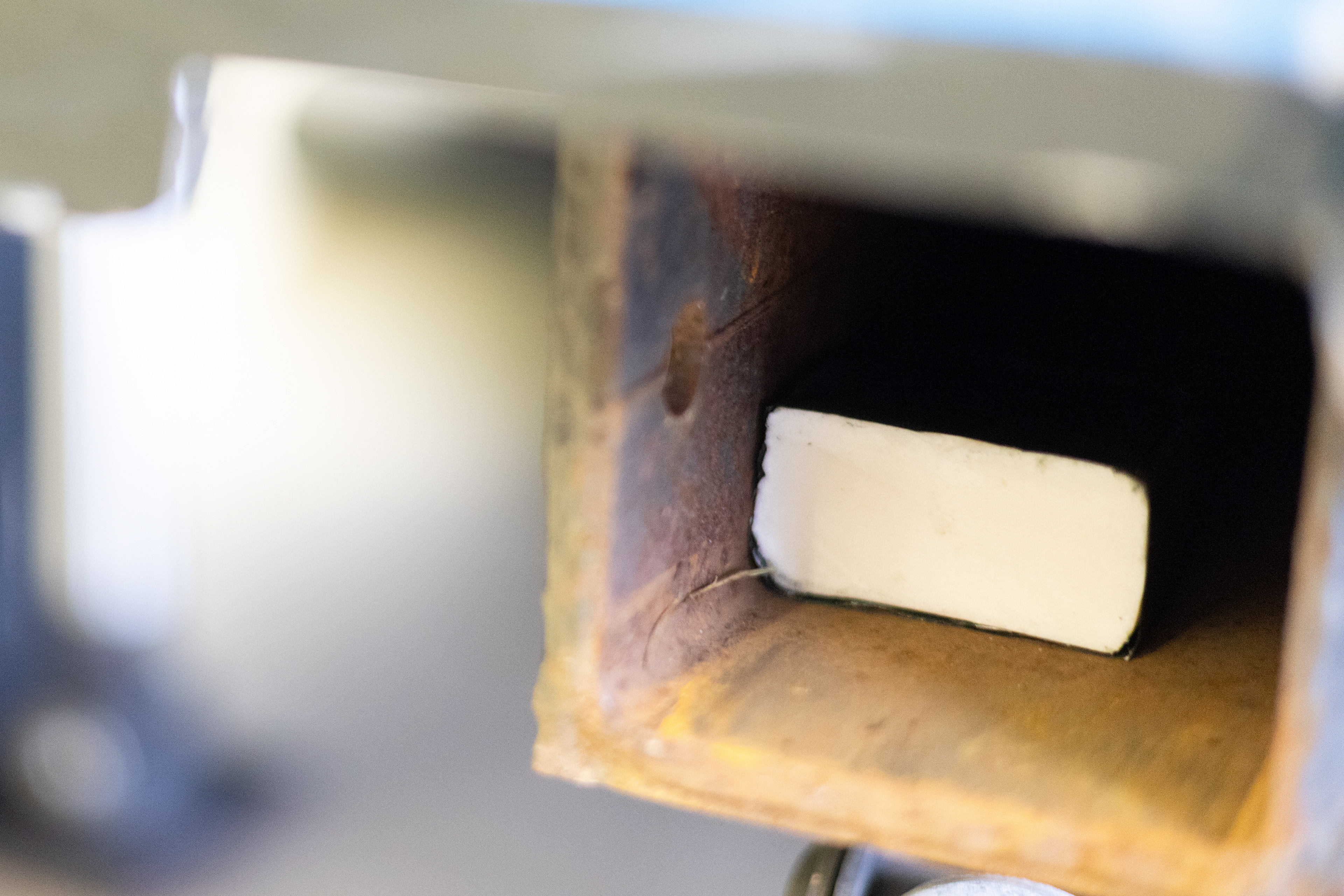 A piece of C-4 sits in the receiver hitch of a food truck in the Convocation Center in Athens, Ohio, Dec. 5, 2023. C-4 is one of the 27 explosive chemicals Bach can smell. They must train with each chemical to keep it in Bach’s arsenal. “Some officers only train with their dogs once a month. They then go back to the academy for testing and fail. We train almost every day,” King said.