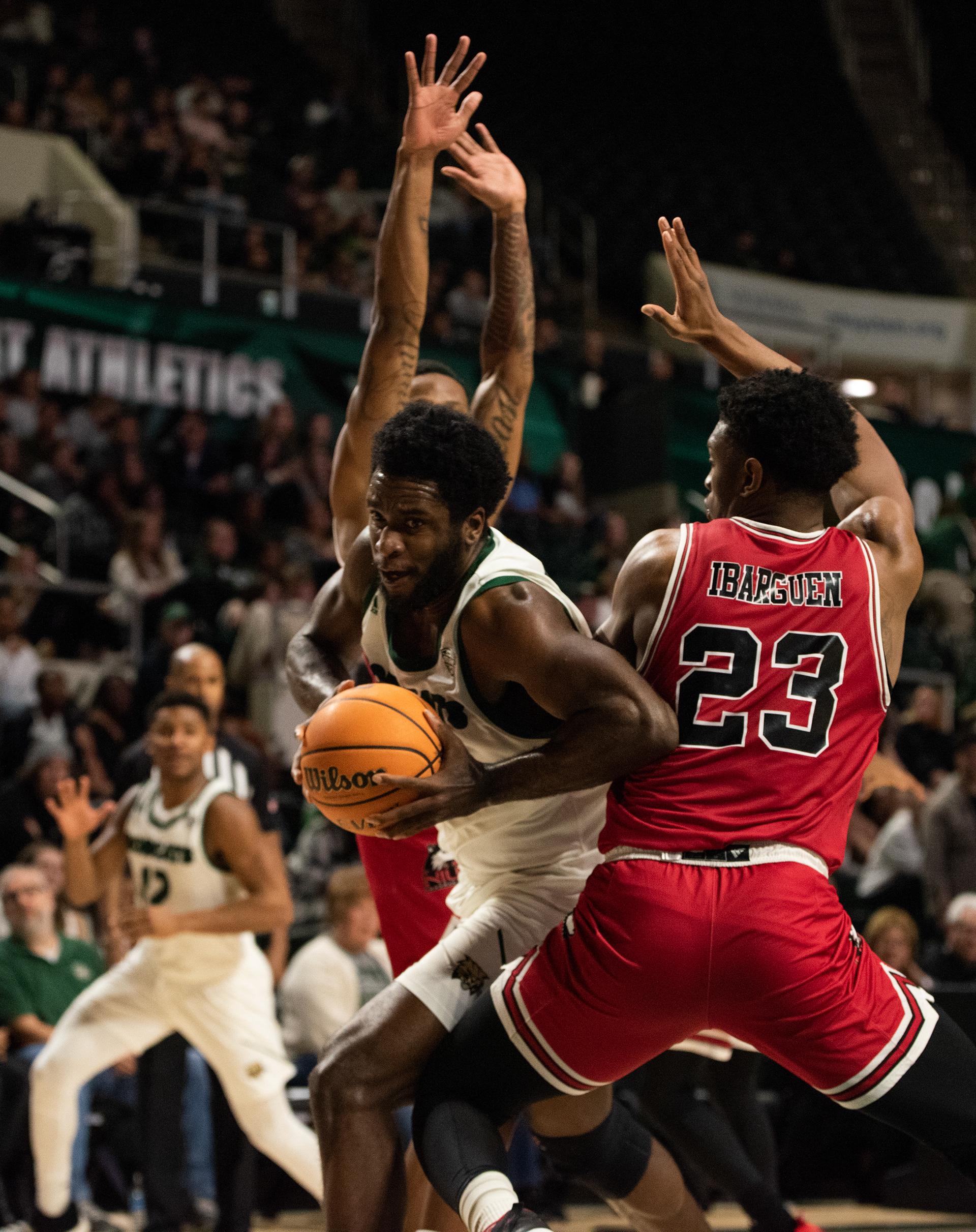 Ohio University’s Dwight Wilson III (4) drives for a layup against Northern Illinois defender at the Convocation Center on February 21, 2023.