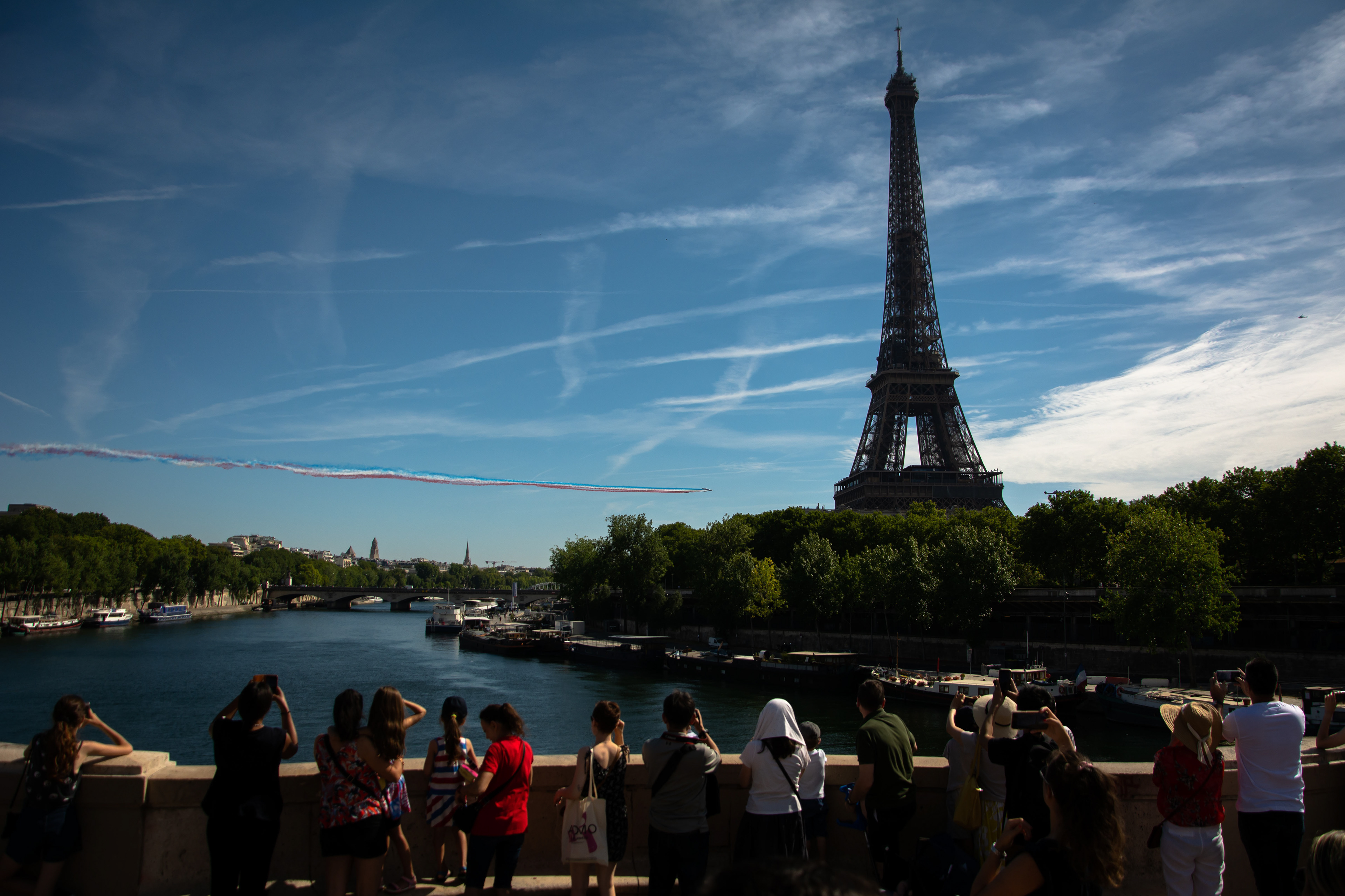 Patrouille de France releases smoke in the colors of the French flag as they fly behind Eiffel Tower during Bastille Day in Paris, on July 14, 2022.