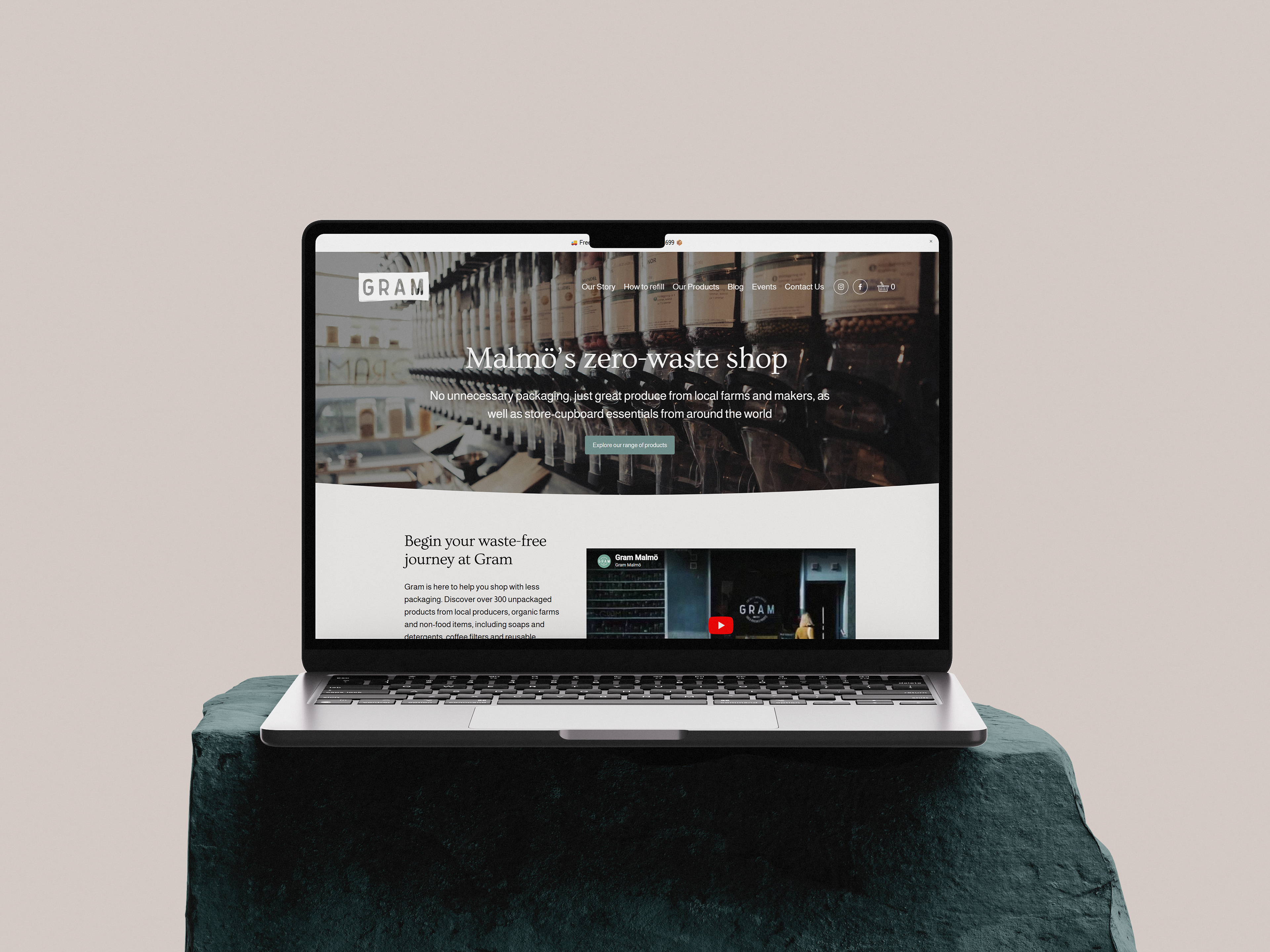 Laptop on stone platform, showing landing page of the redesigned website