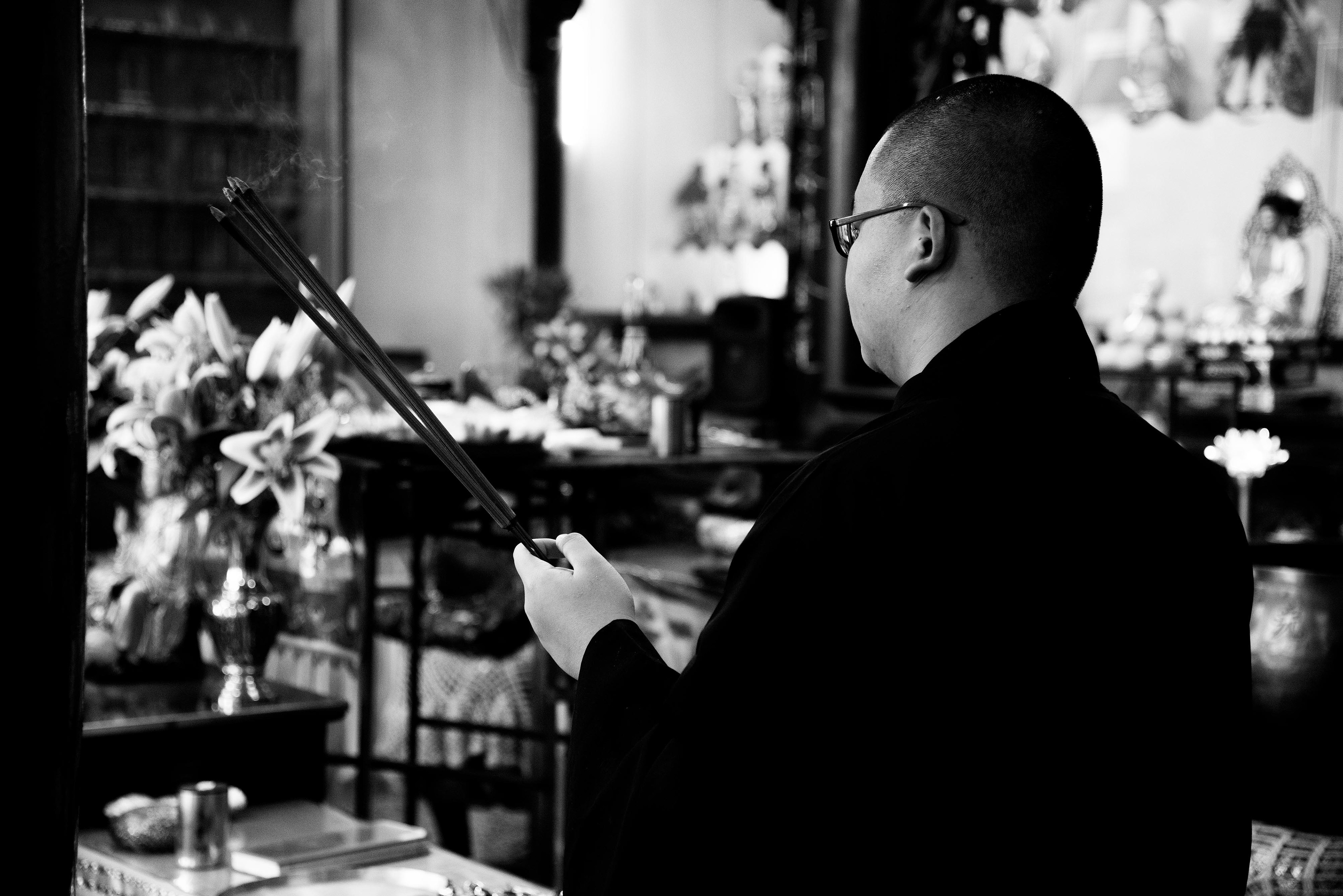 a young devotee brings incense for the prayer
