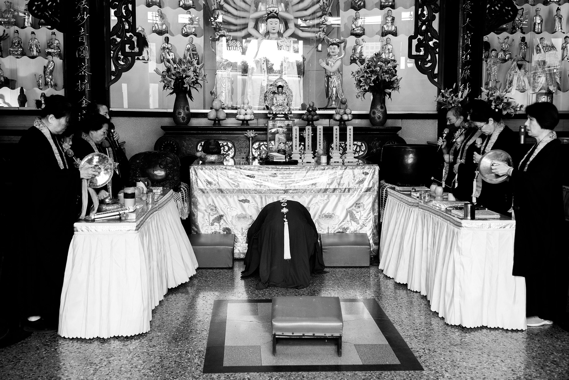the temple’s elder monk shows his deep respect to the Buddha