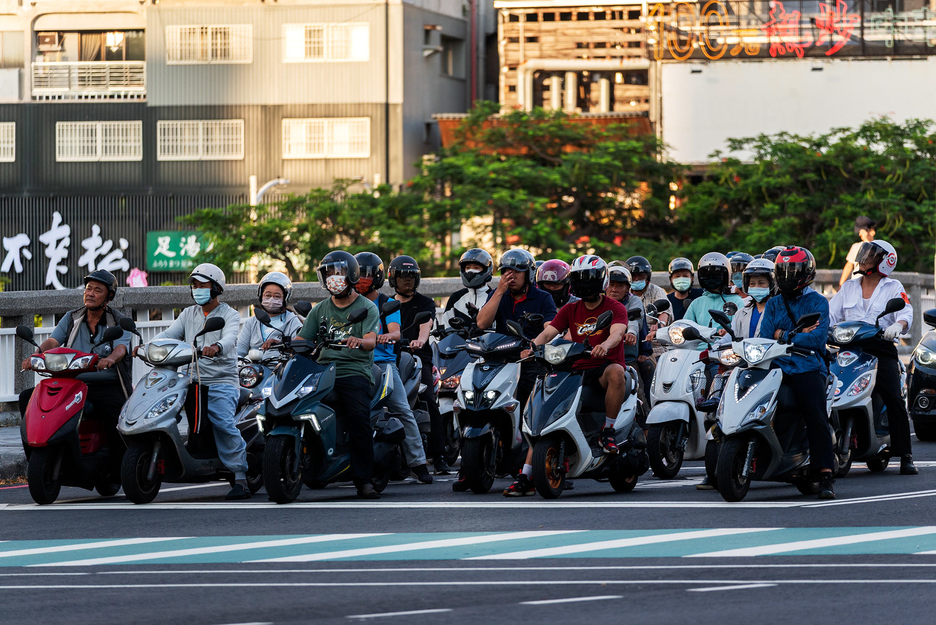 scooters stopped at the traffic light in the designated area