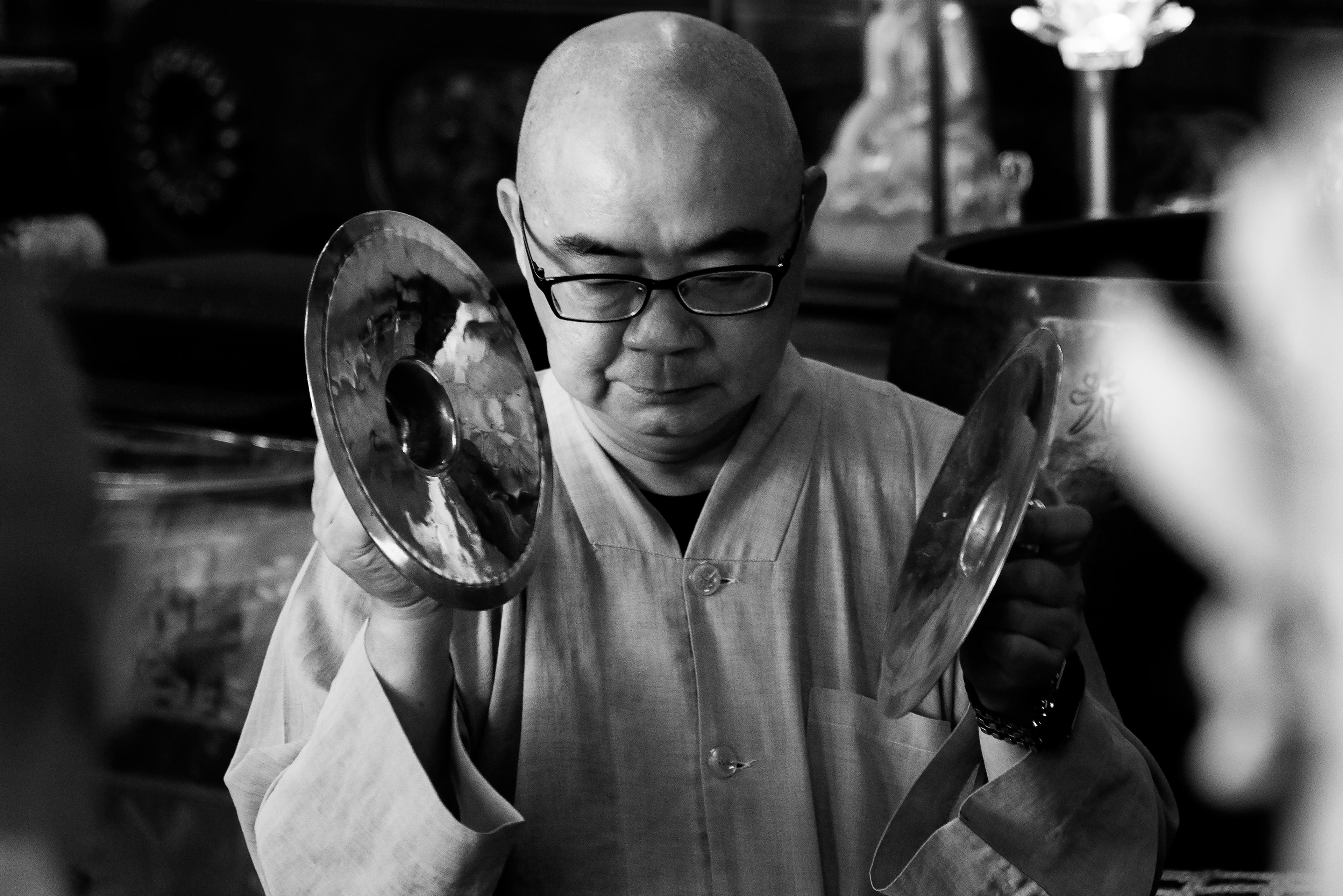 a young monk uses the tingsha