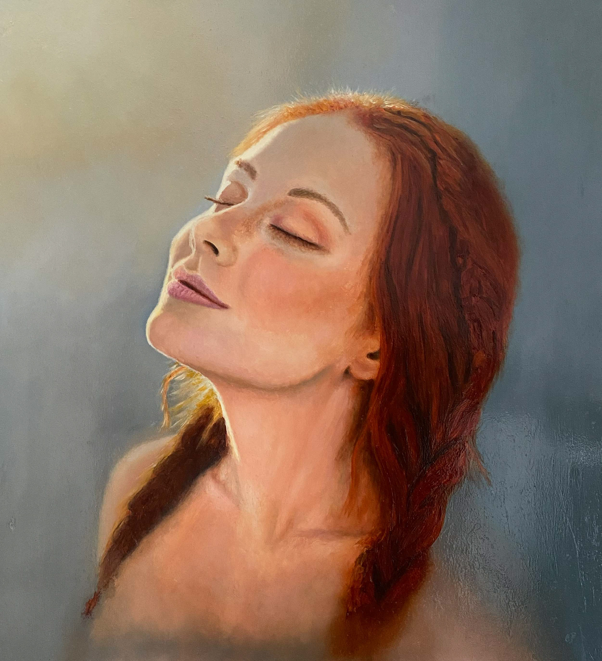 Portrait of a young red haired woman enjoing the warm spring sun.